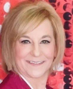 Close up photograph of Paula Yevincy smiling at the camera.