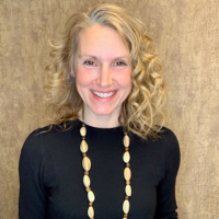 Hope smiling at the camera wearing a black shirt.