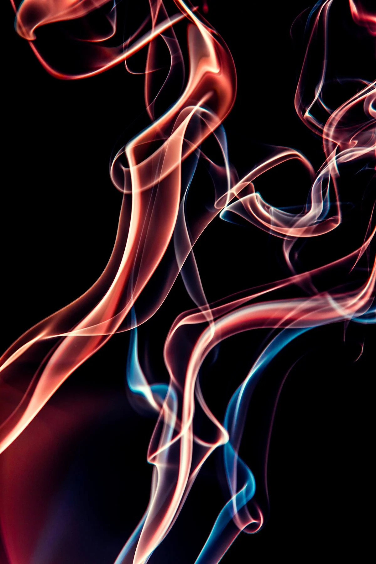 Colorful swirling smoke patterns against a black background.