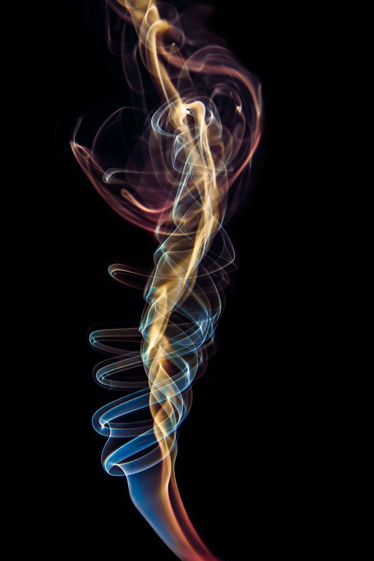 Colorful swirling smoke against a black background.