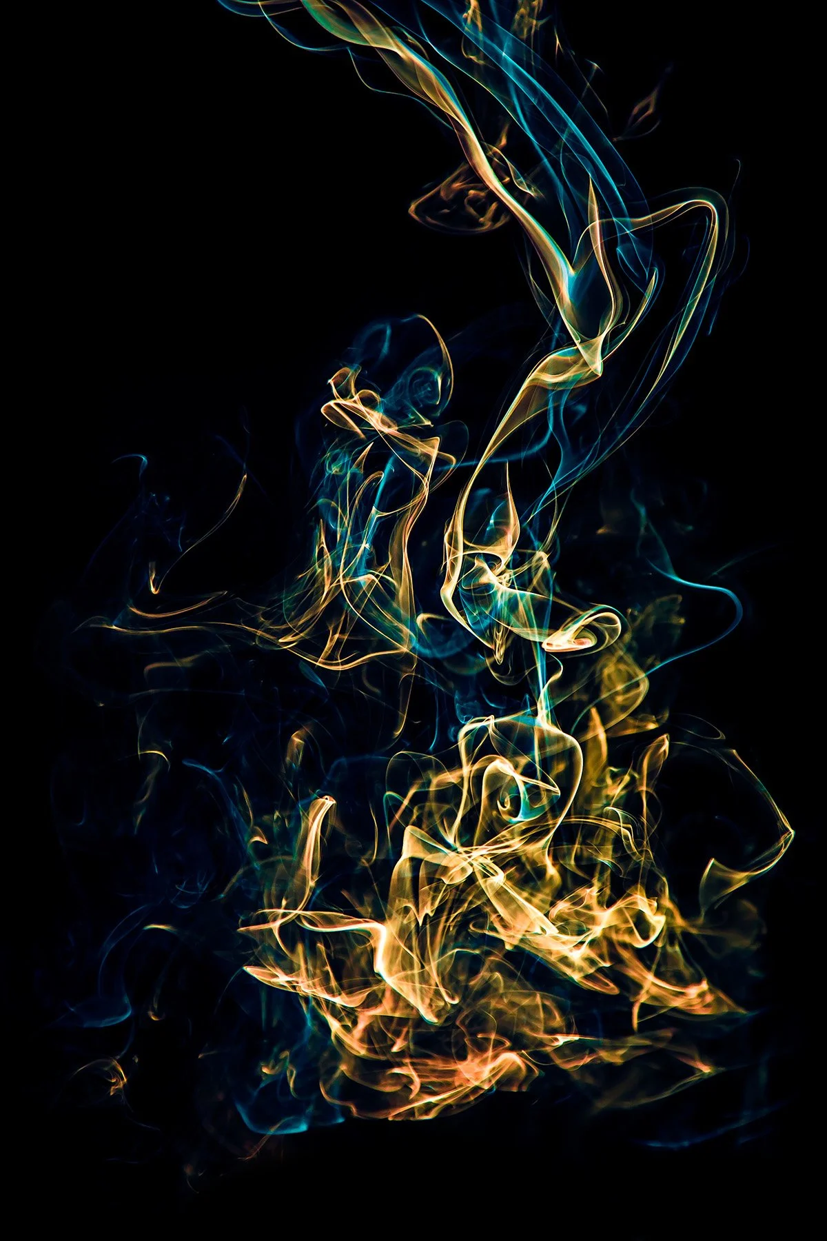 Colorful wisps of abstract smoke or light trails against a black background.