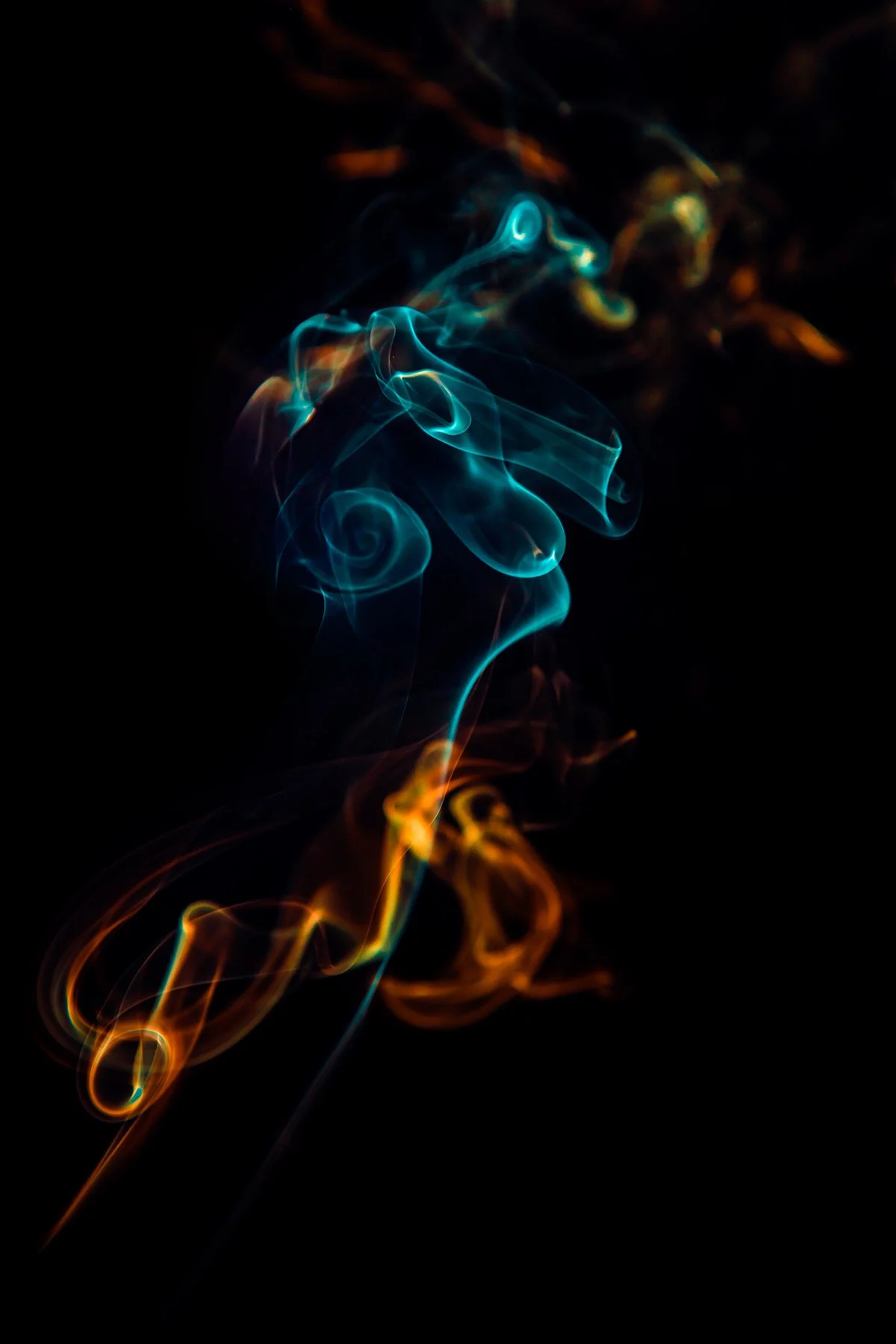 Colorful swirling smoke against a black background
