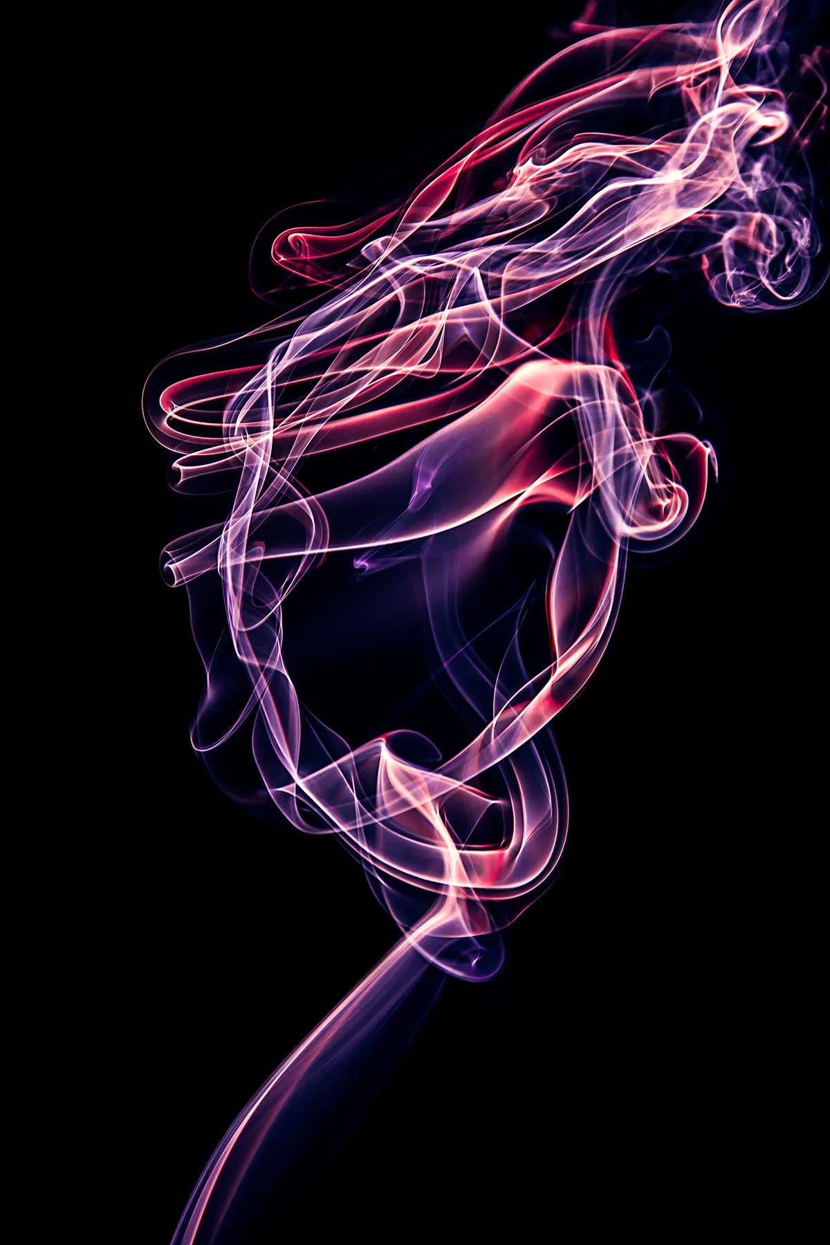 Colorful, wispy smoke tendrils swirling against a black background, with pink, purple, and white hues.