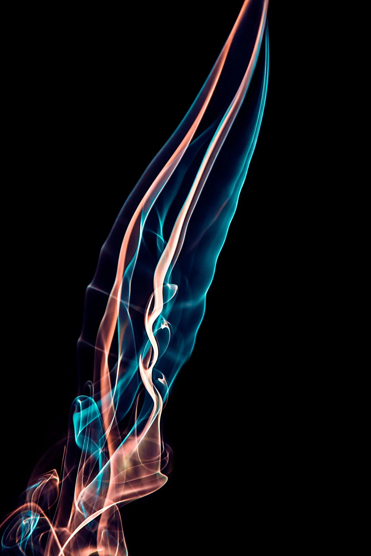 Colorful, wispy smoke trails on a black background with shades of blue, orange, and white.