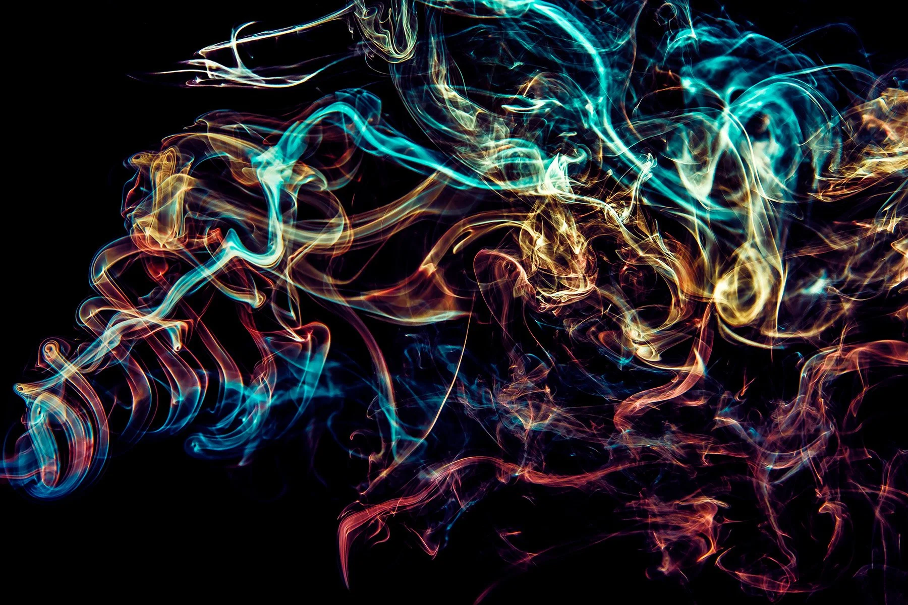 Colorful, swirling smoke or abstract light trails against a black background.