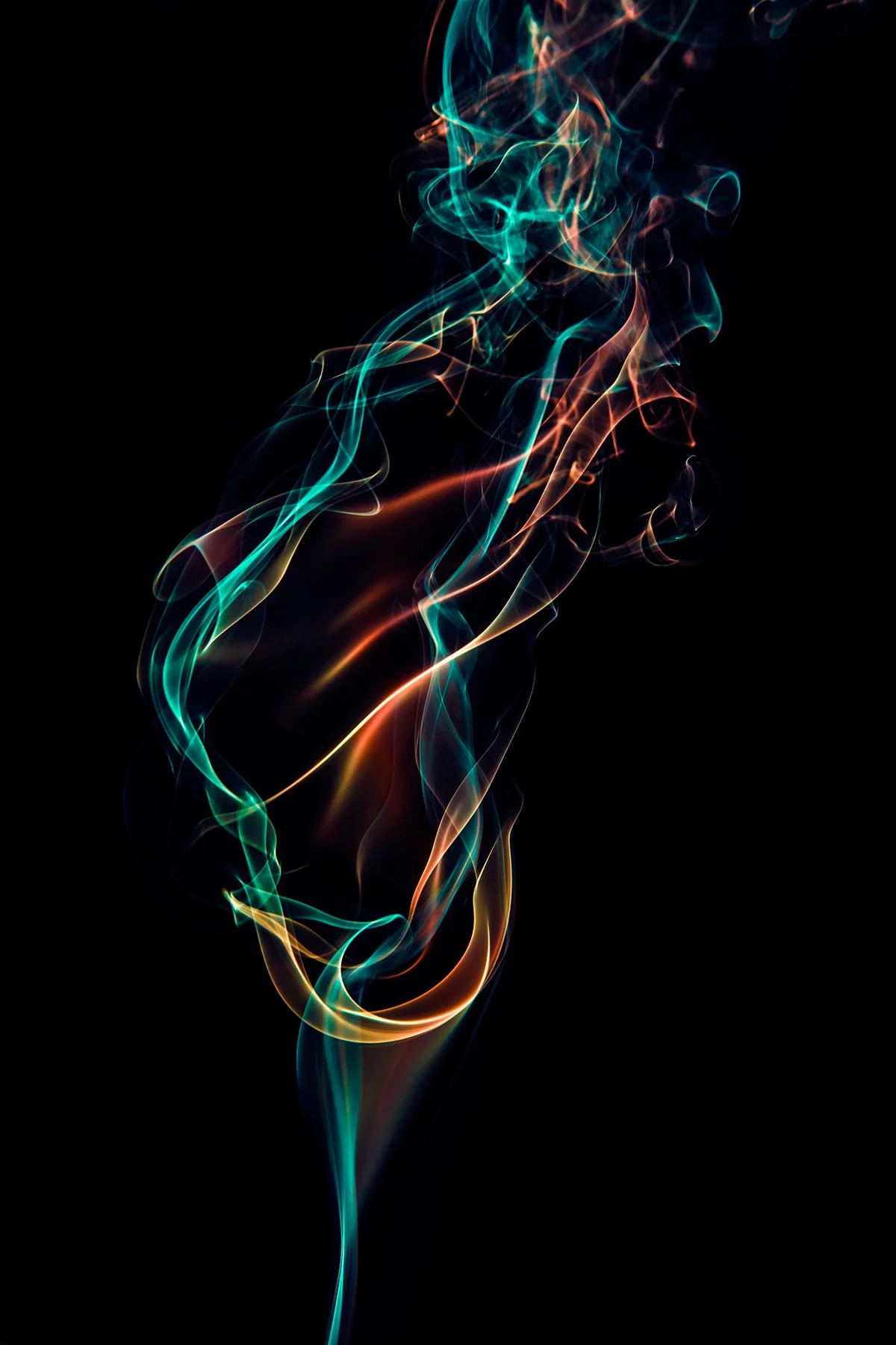 Colorful wisps of smoke or light against a black background, creating swirling patterns.