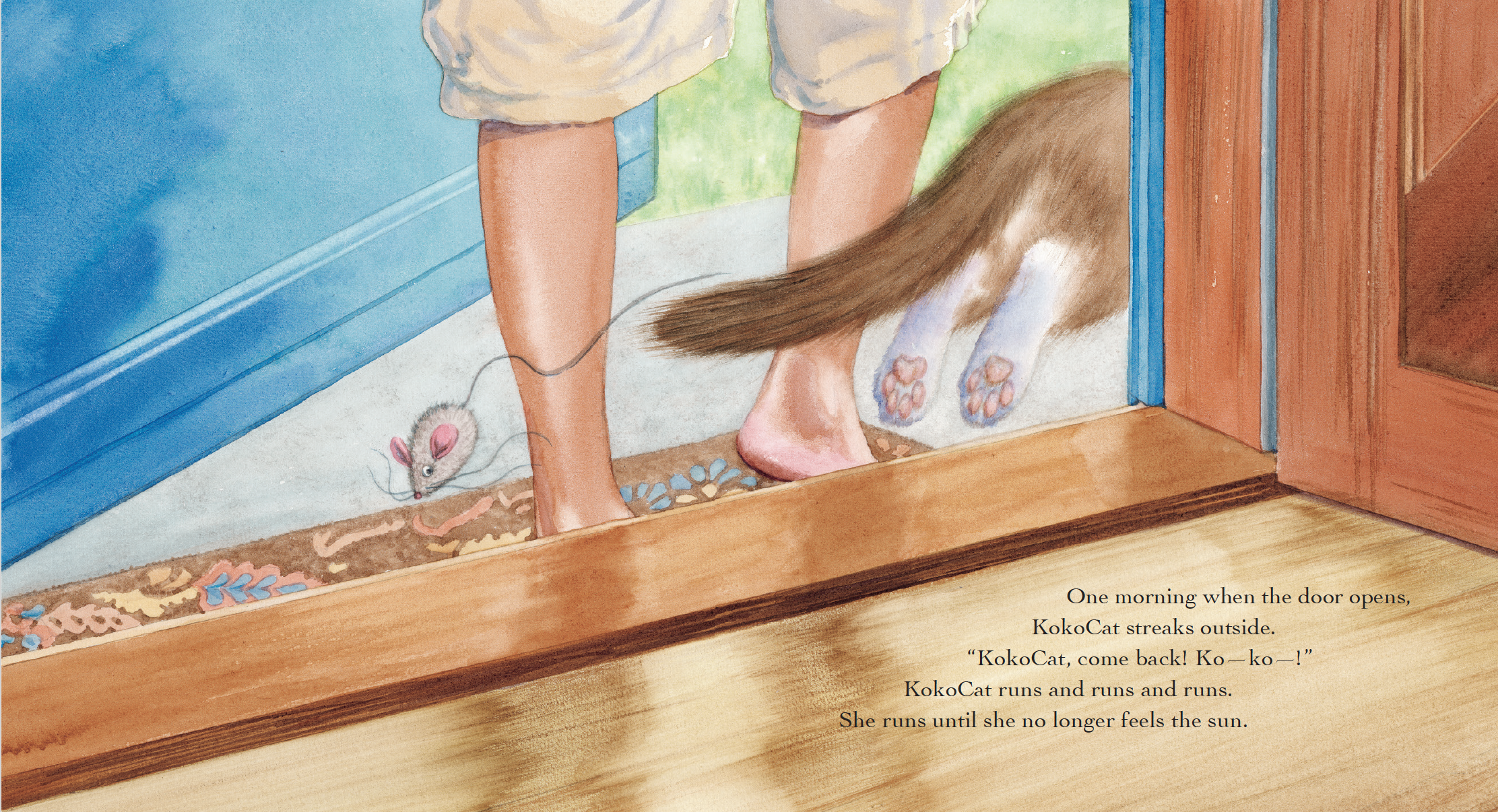 A cat runs outside a house, chasing a small mouse on a leash held by a person whose legs are visible. The person is barefoot and standing on a wooden floor, with a blue wall on one side and green grass visible outside.