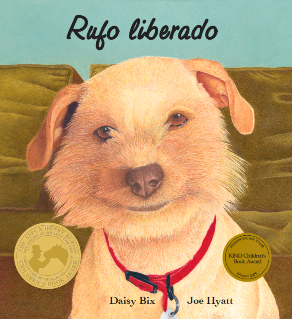 Illustration of a smiling dog with a red collar, titled 'Rufo liberado'. The cover features two gold award medals, one from the ASPCA Henry Bergh Children's Book Award and another from the Humane Society Youth, for children's book awards in 2009. Authors Daisy Bix and Joe Hyatt are listed at the bottom.