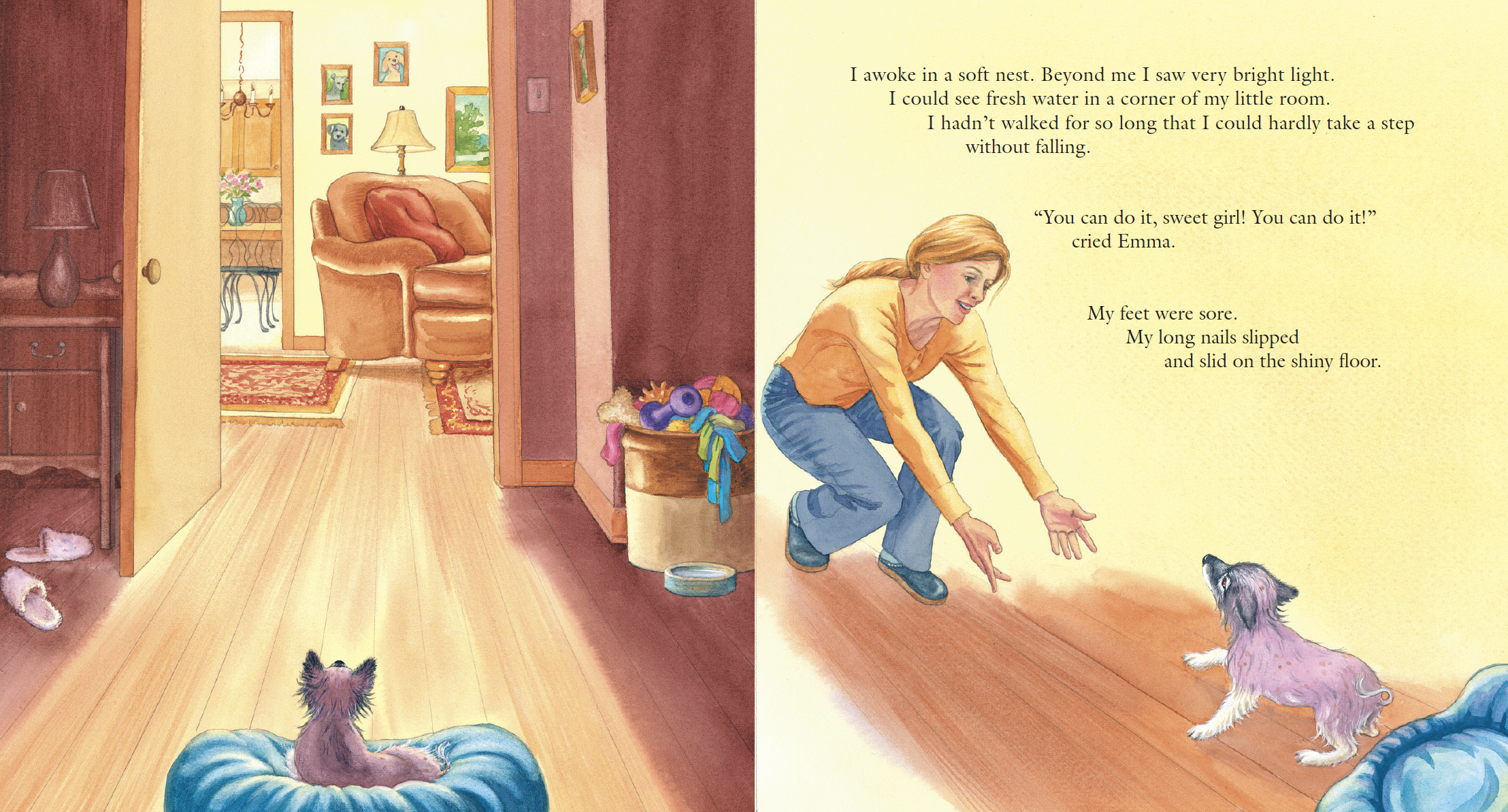 A toddler-sized pink and brown puppy sitting on a blue cushion on a wooden floor, looking at a woman crouching in front of it, on a bright yellow wall with text, in a cozy home with a living room and hallway visible in the background.