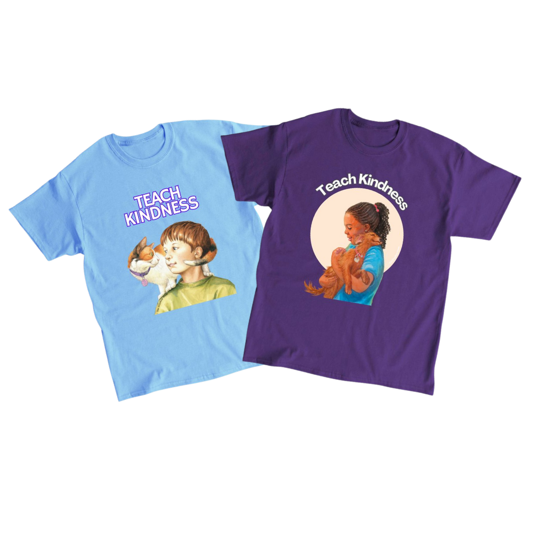Two T-shirts with illustrations of children and the words "Teach Kindness" on them. The blue shirt features a boy with a cat, and the purple shirt features a girl hugging a dog.