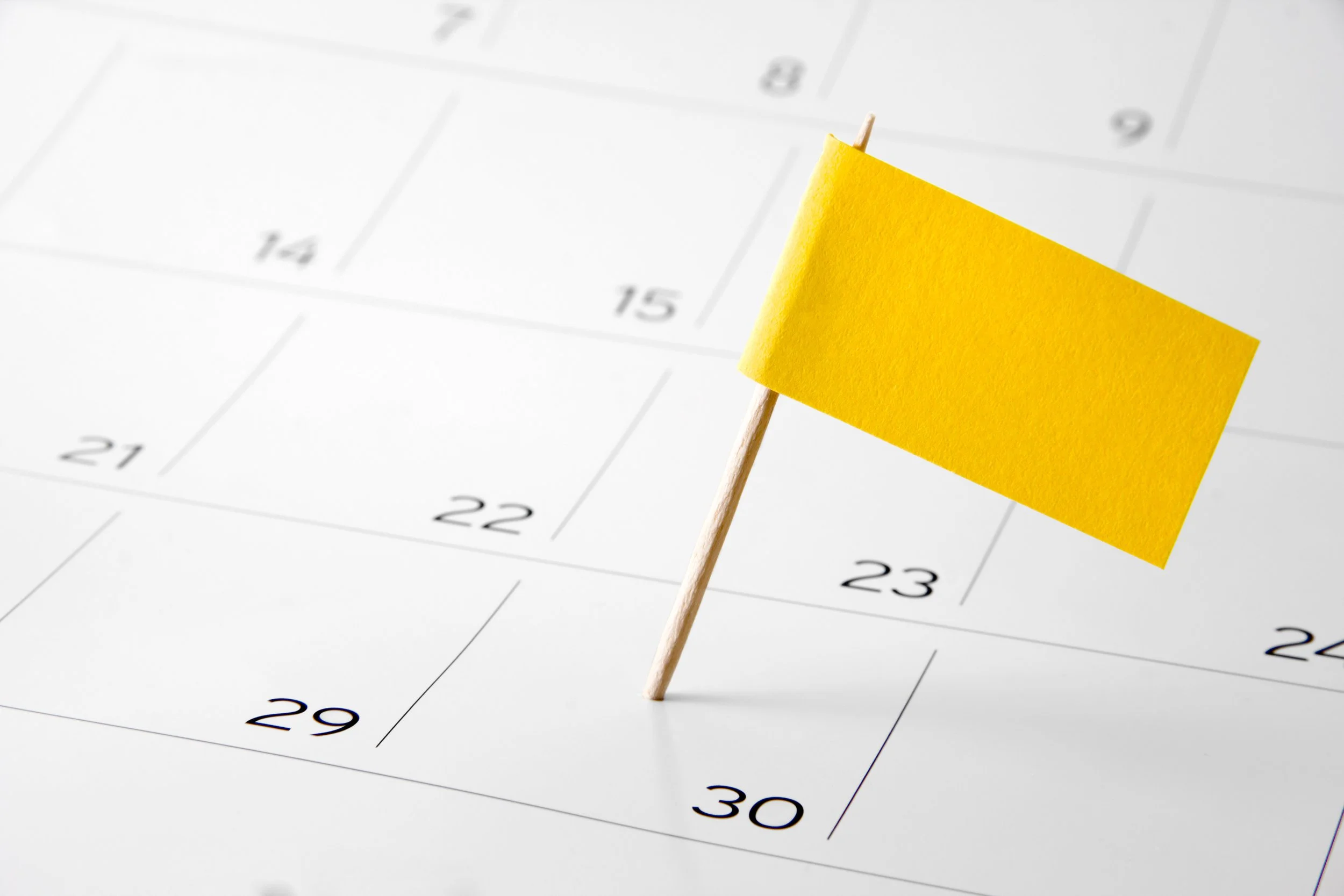 Yellow flag planted into a calendar date