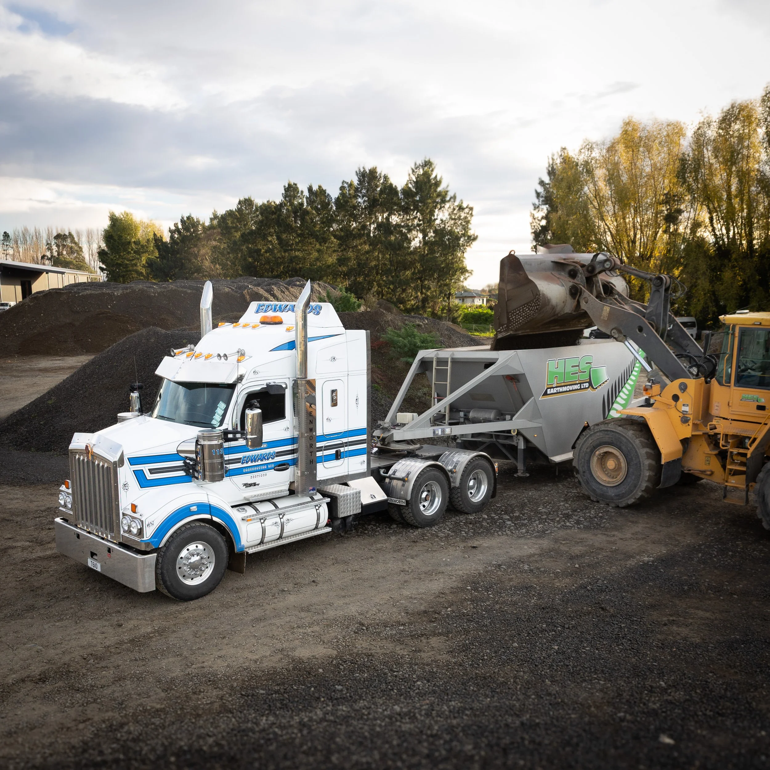 An Edwards Contracting white and blue semi-truck in a gravel yard in Hastings, Hawke's Bay. Edwards are Hawkes Bay experts at earth moving and trucking