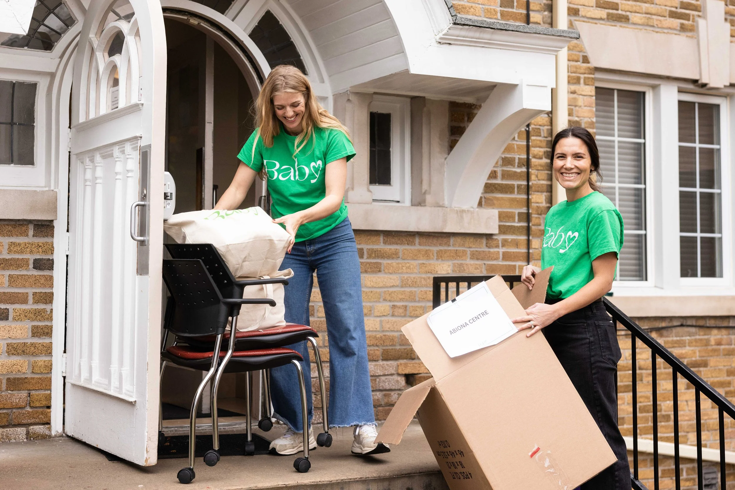 Baby Love volunteers unpack gift bags at one of the organization's partner agencies, Abiona Centre.