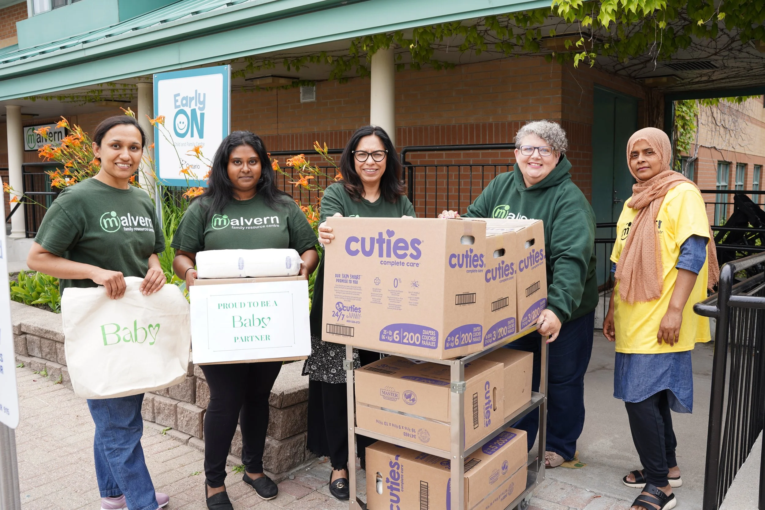 Staff from Malvern Family Resource Centre show how the are proud to be a Baby Love partner