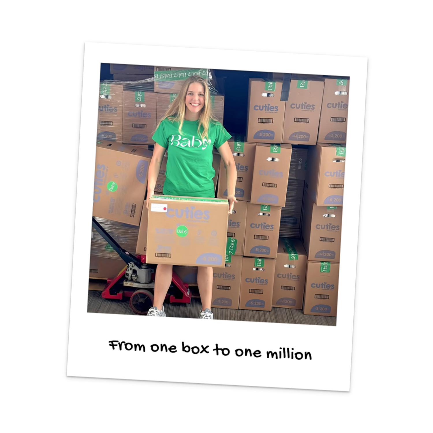 Julia holds a box of diapers in front of a packed truck, celebrating 1M diapers delivered to Toronto families