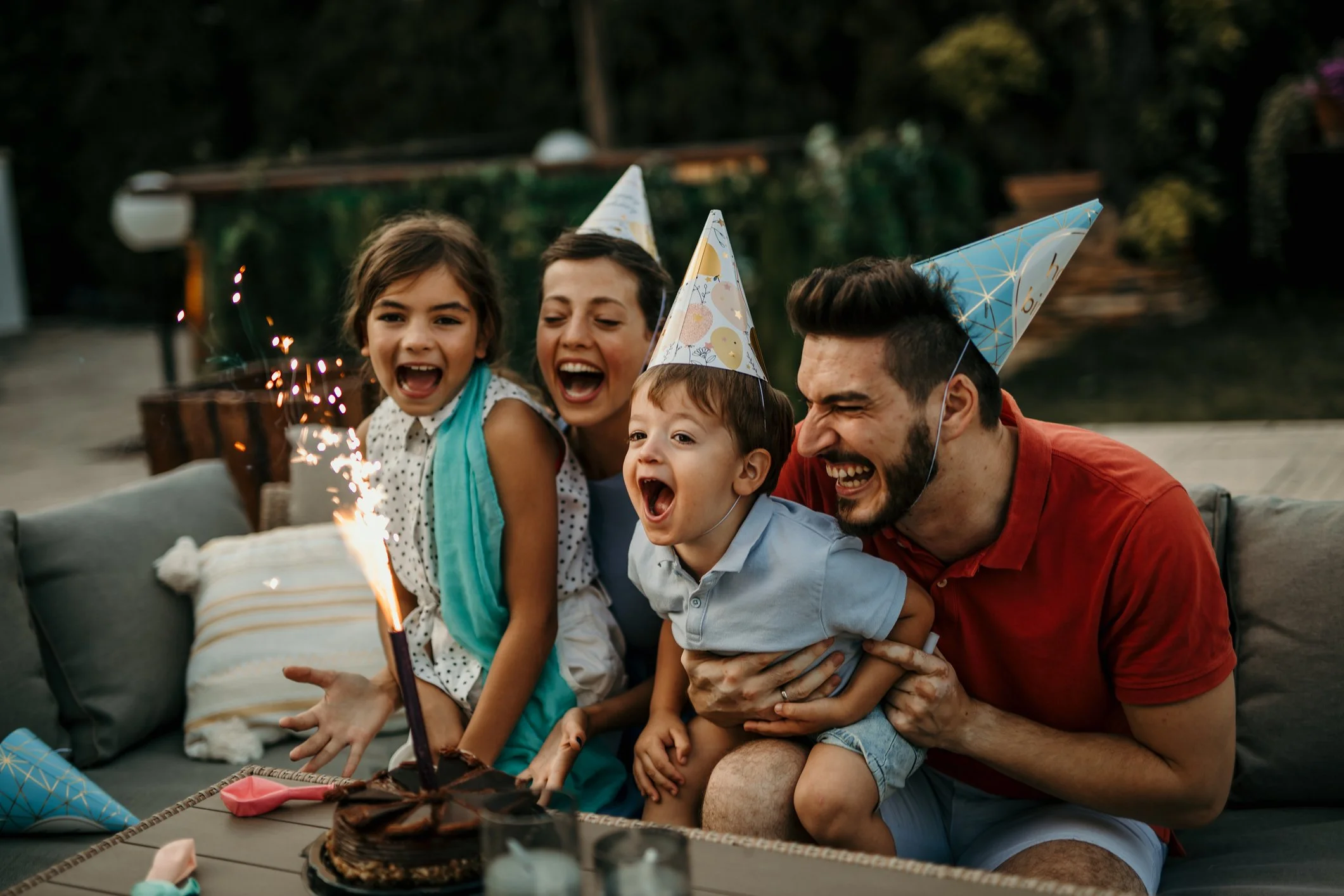 A family blows out the candles on a cake