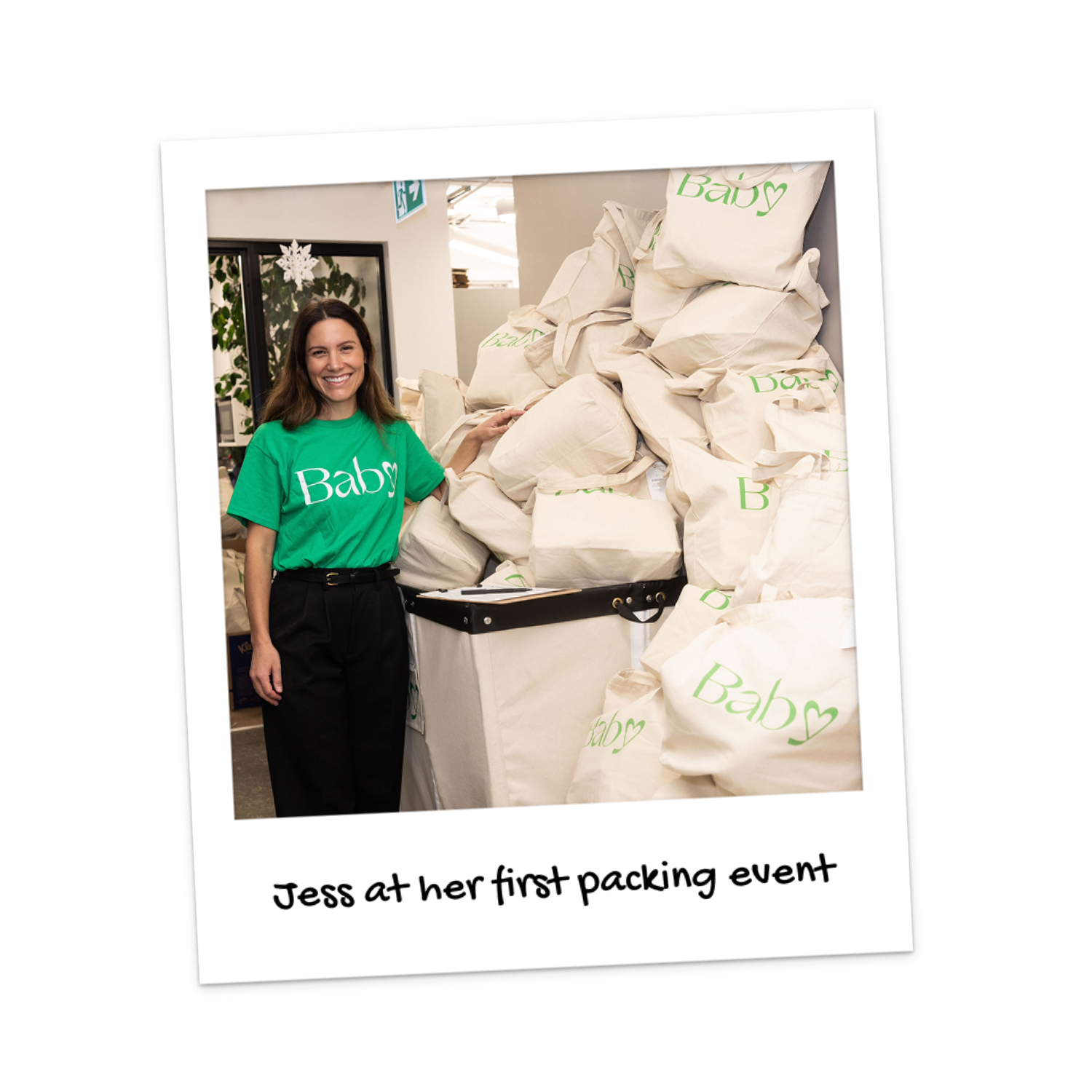Baby Love's Executive Director, Jess, is shown in front of packed gift bags at her first packing event