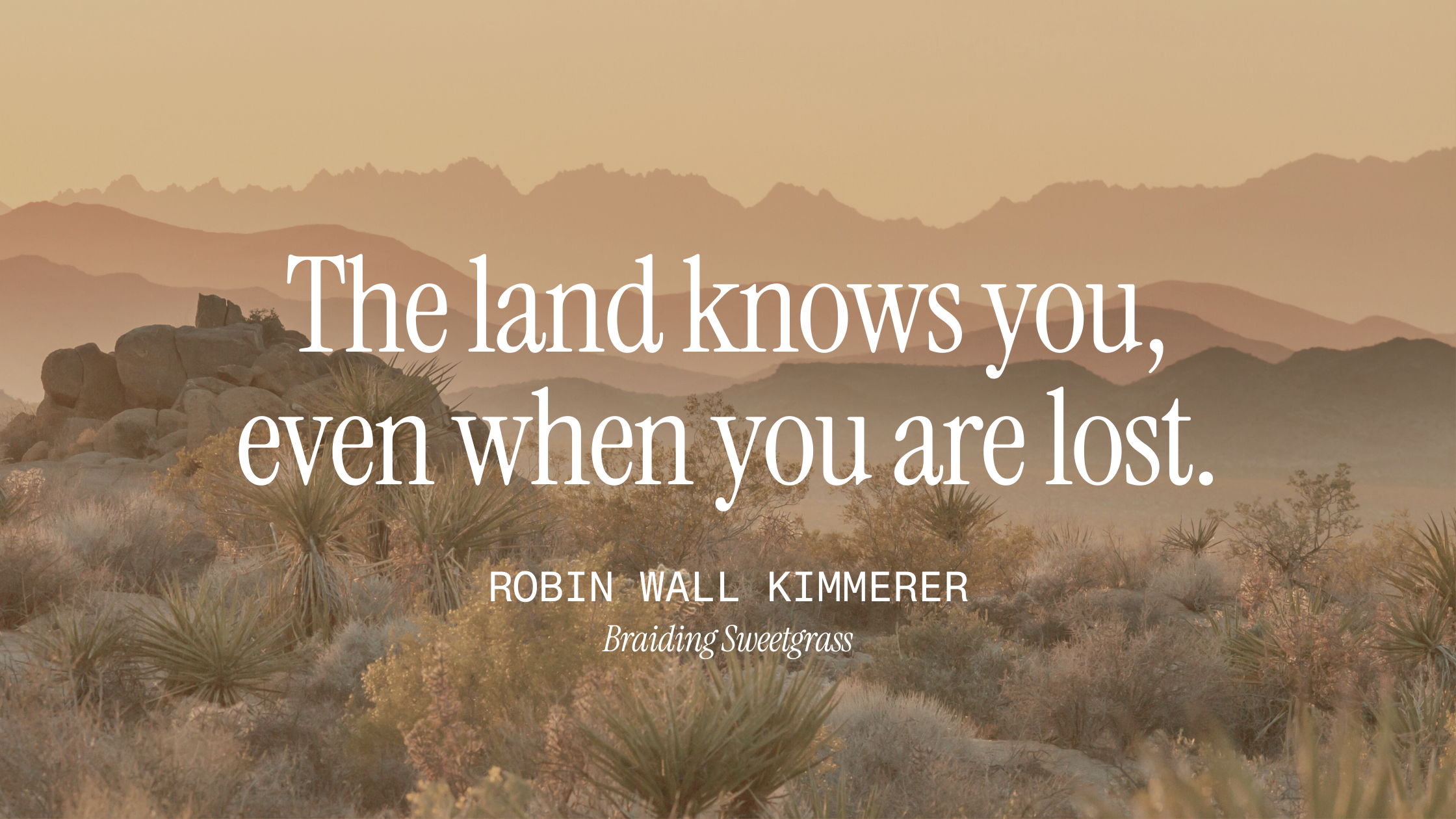Over a desert background with sagebrush, cacus, yucca, and beautiful mountains, the words "The land knows you, even when you are lost." Robin Wall Kimmerer Braiding Sweetgrass are overlaid, as a nod to the fact that astrocartography helps you ground
