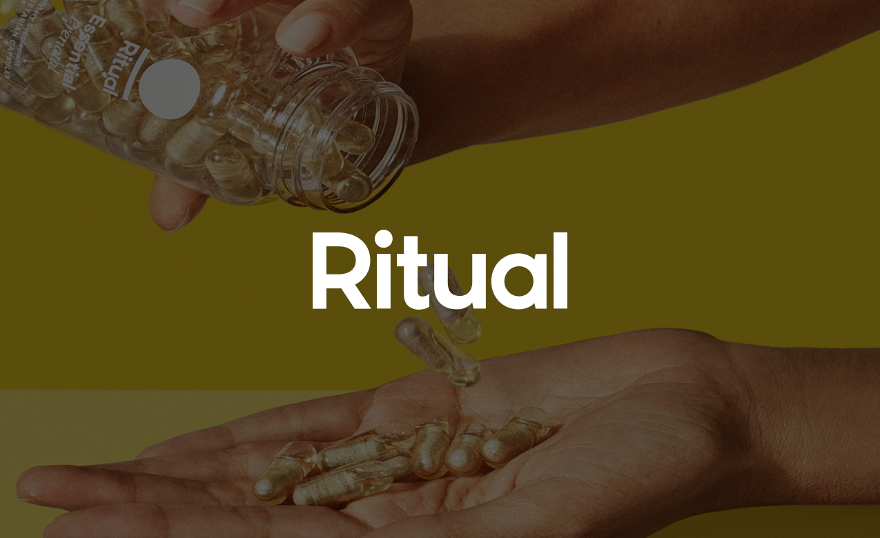 A person is pouring capsules from a plastic bottle into their hand. The word "Ritual" is overlaid on the image.