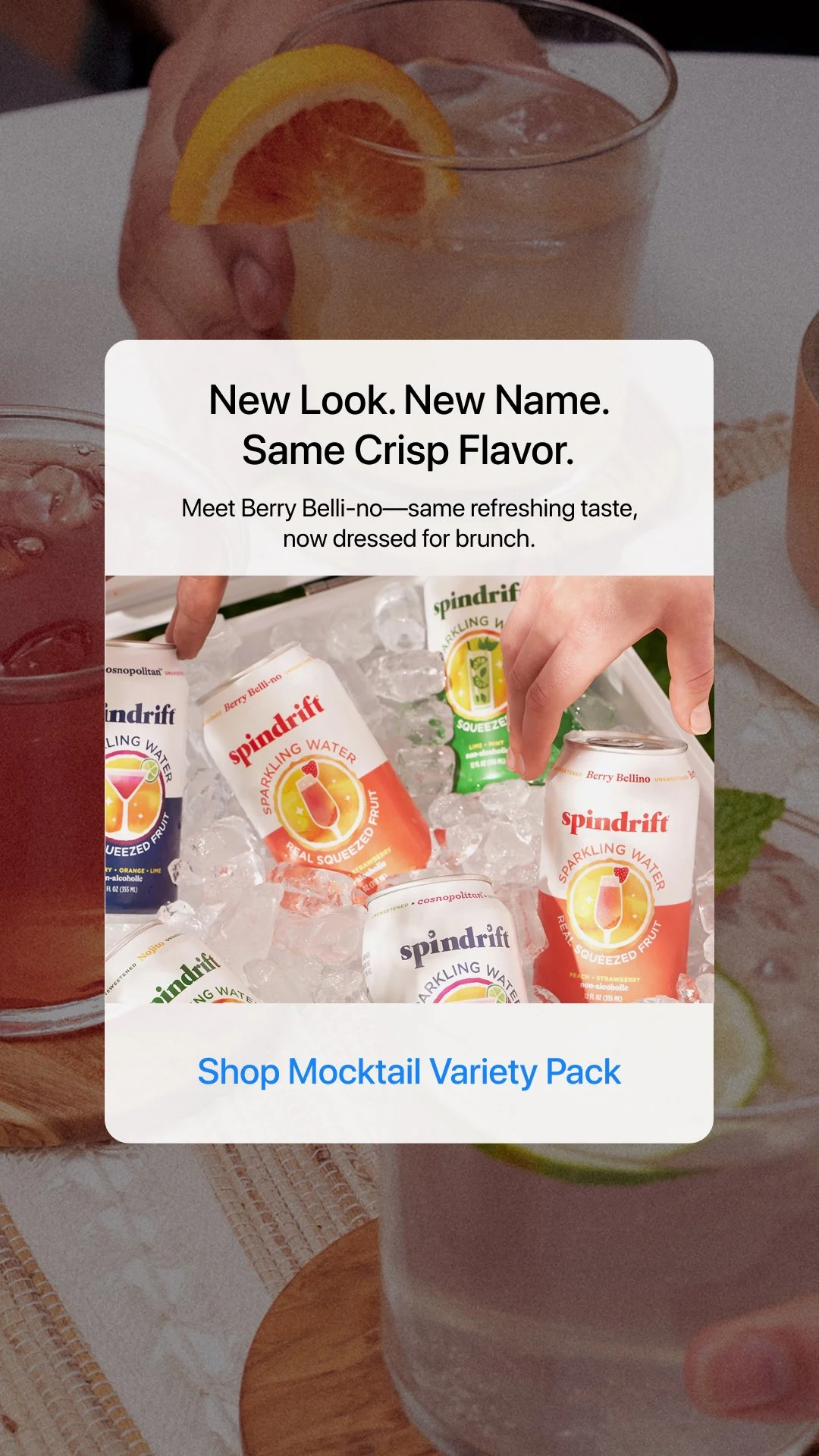 A promotional image featuring cans of Spindrift sparkling water flavored with real fruit, with one hand holding a glass of sparkling water with an orange slice, and another hand reaching for a can of strawberry flavored sparkling water.
