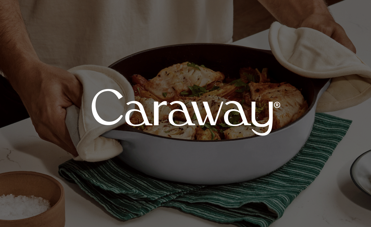 Person removing a hot dish from oven using oven mitts, with cooked chicken in a baking dish.