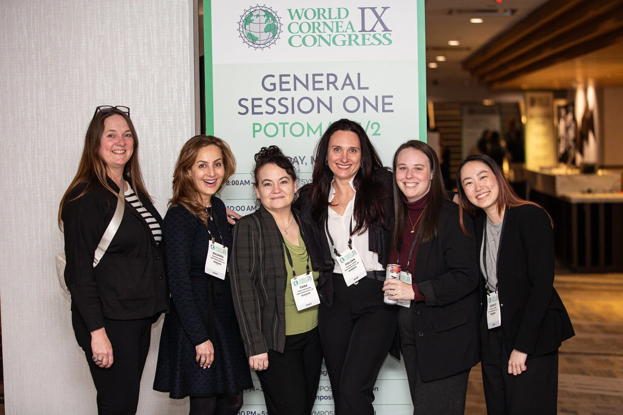A group of professionals gather for a photo at the World Cornea Congress IX, capturing a moment of connection and collaboration during the international medical conference. Standing together in front of event signage, the attendees showcase the netwo