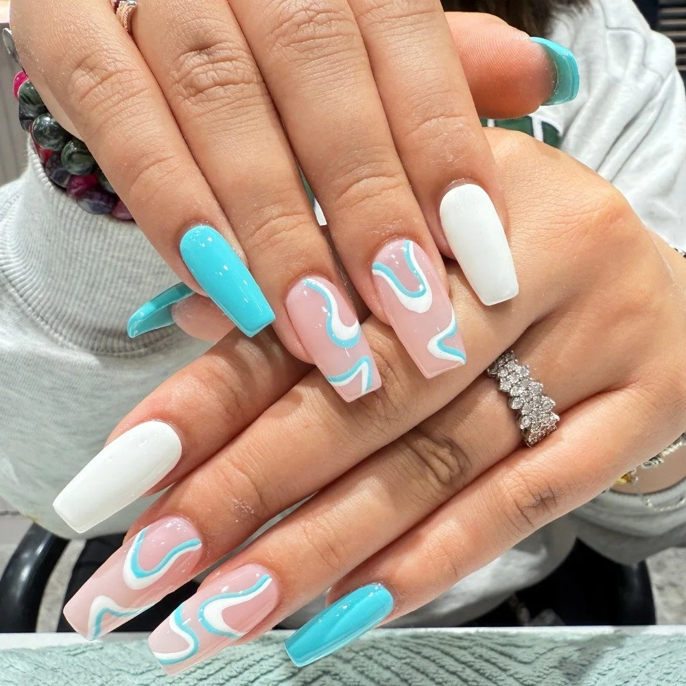 Ocean breeze vibes 🌊

Aqua and white swirl design on a nude base for the perfect mix of classy and fun. 

These coffin acrylic nails bring a touch of summer to any look.

Book online or walk in today. 💅 (Link in bio)