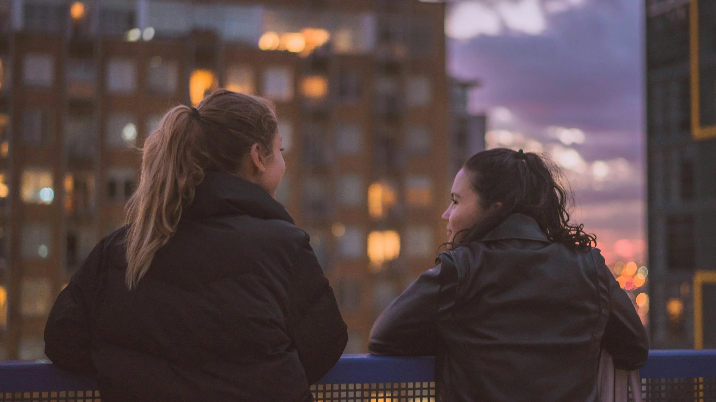 What is RSD? It can impact an ADHDer in any stage of life. Including adolescence. Two girls look out over the city from a balcony.