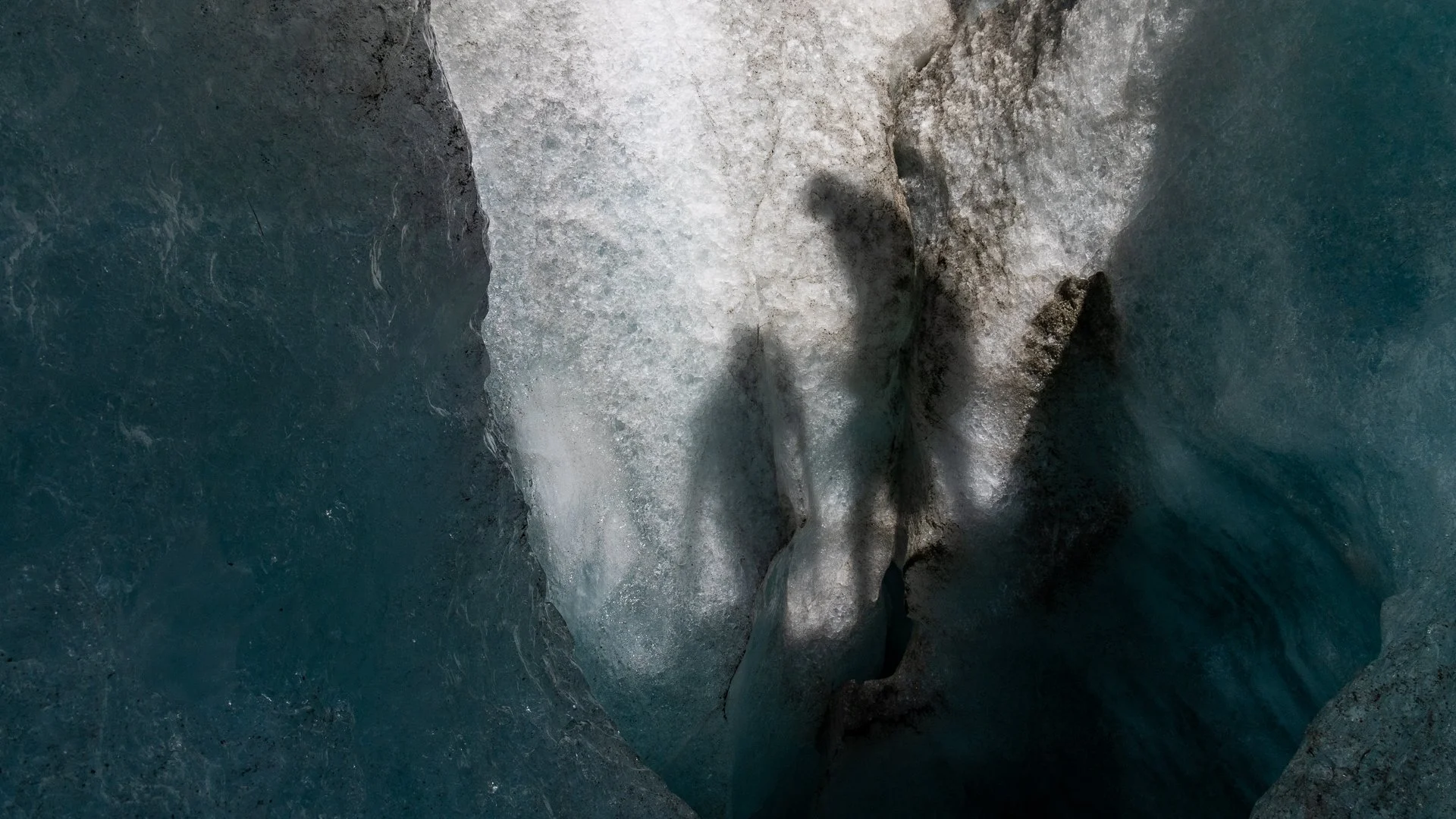 Close-up of ice and water with ice formations and waves, possibly in a glacier or icy water environment.