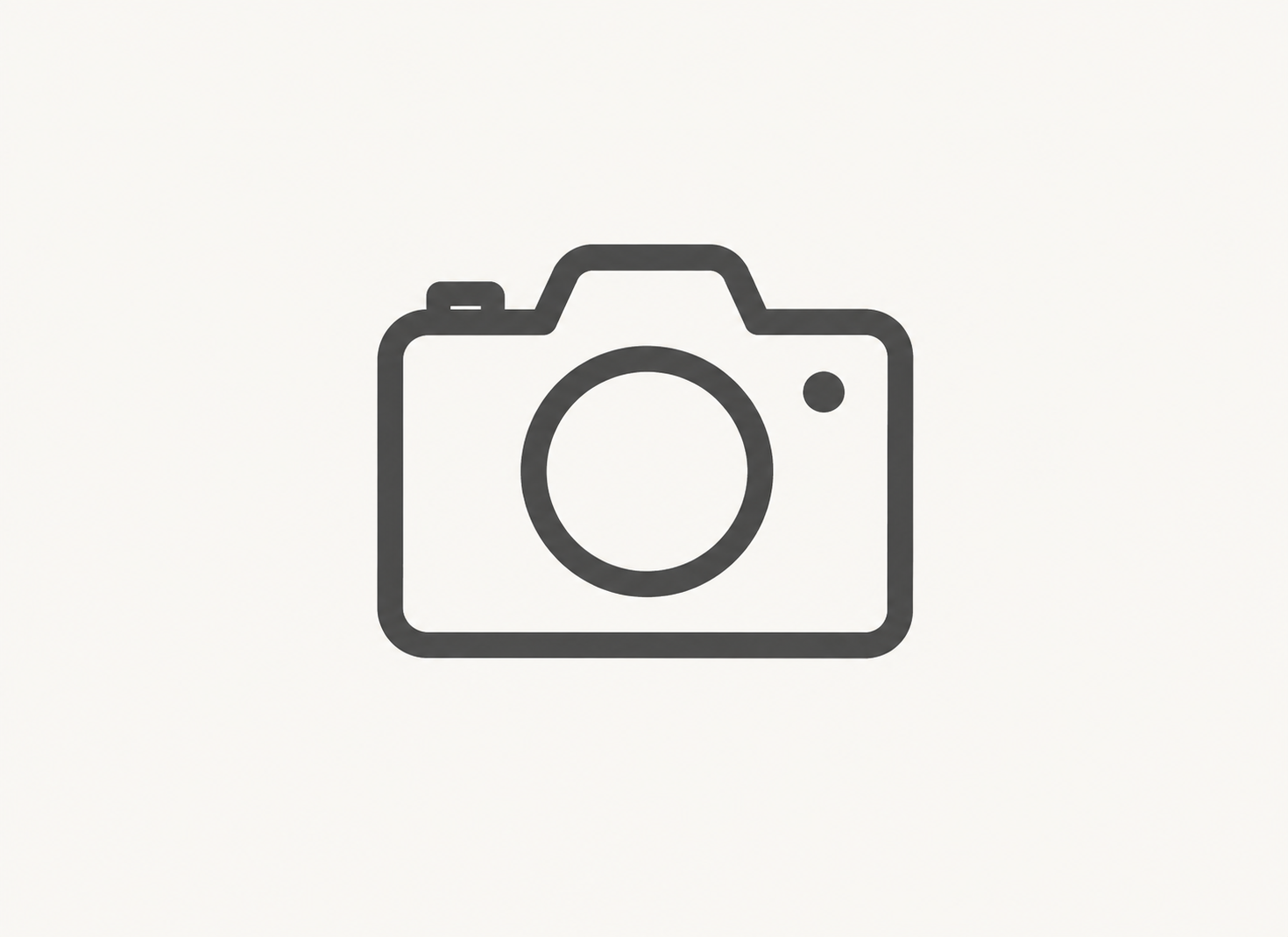 Icon of a camera on a white background.