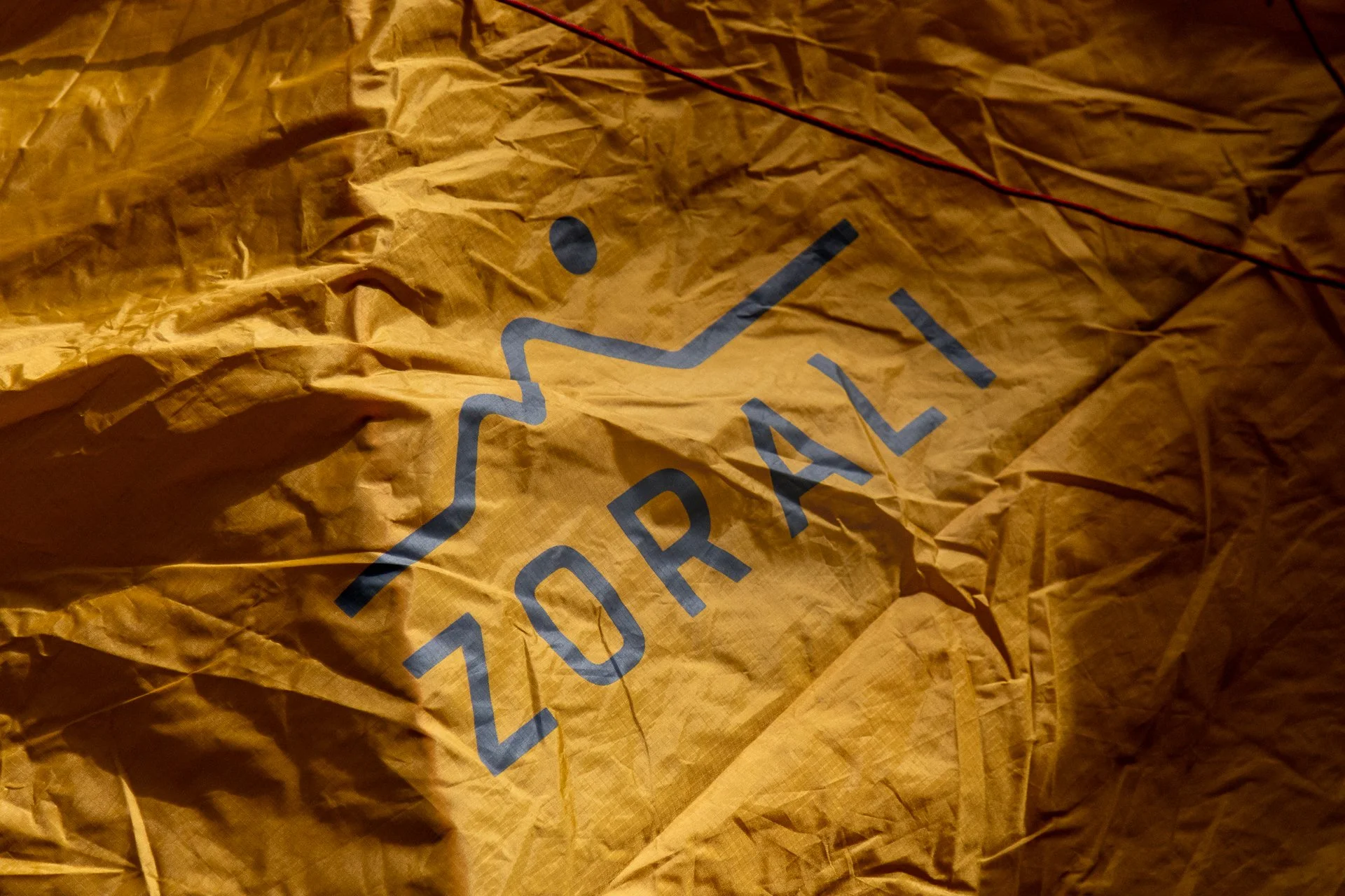 Crumpled brown paper bag with the word 'PORTLAND' printed in blue capital letters and a black and gray wavy line logo.