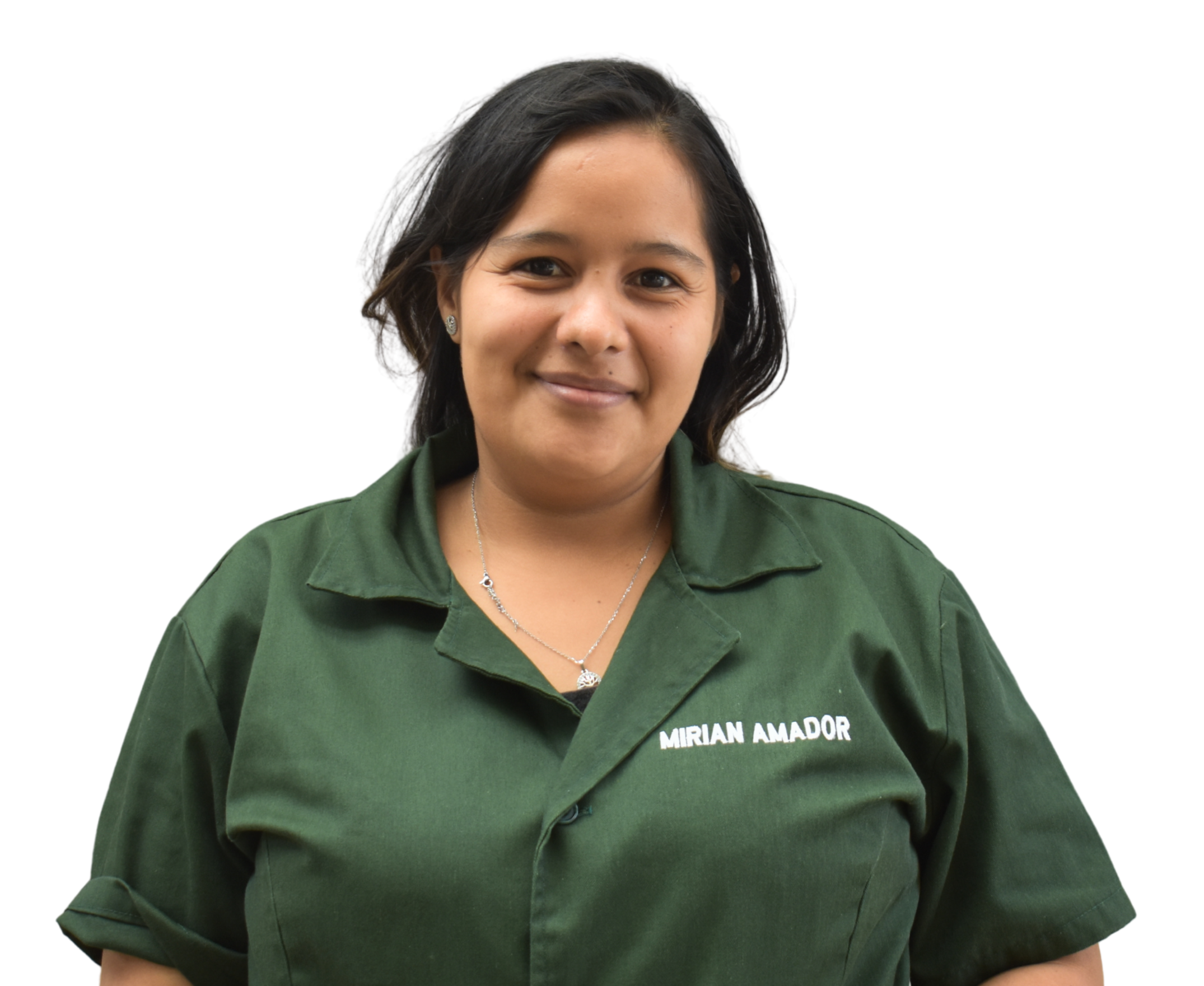 A woman with short dark hair, wearing a green shirt with the name tag 'MIRIAN AMADOR,' smiling at the camera.