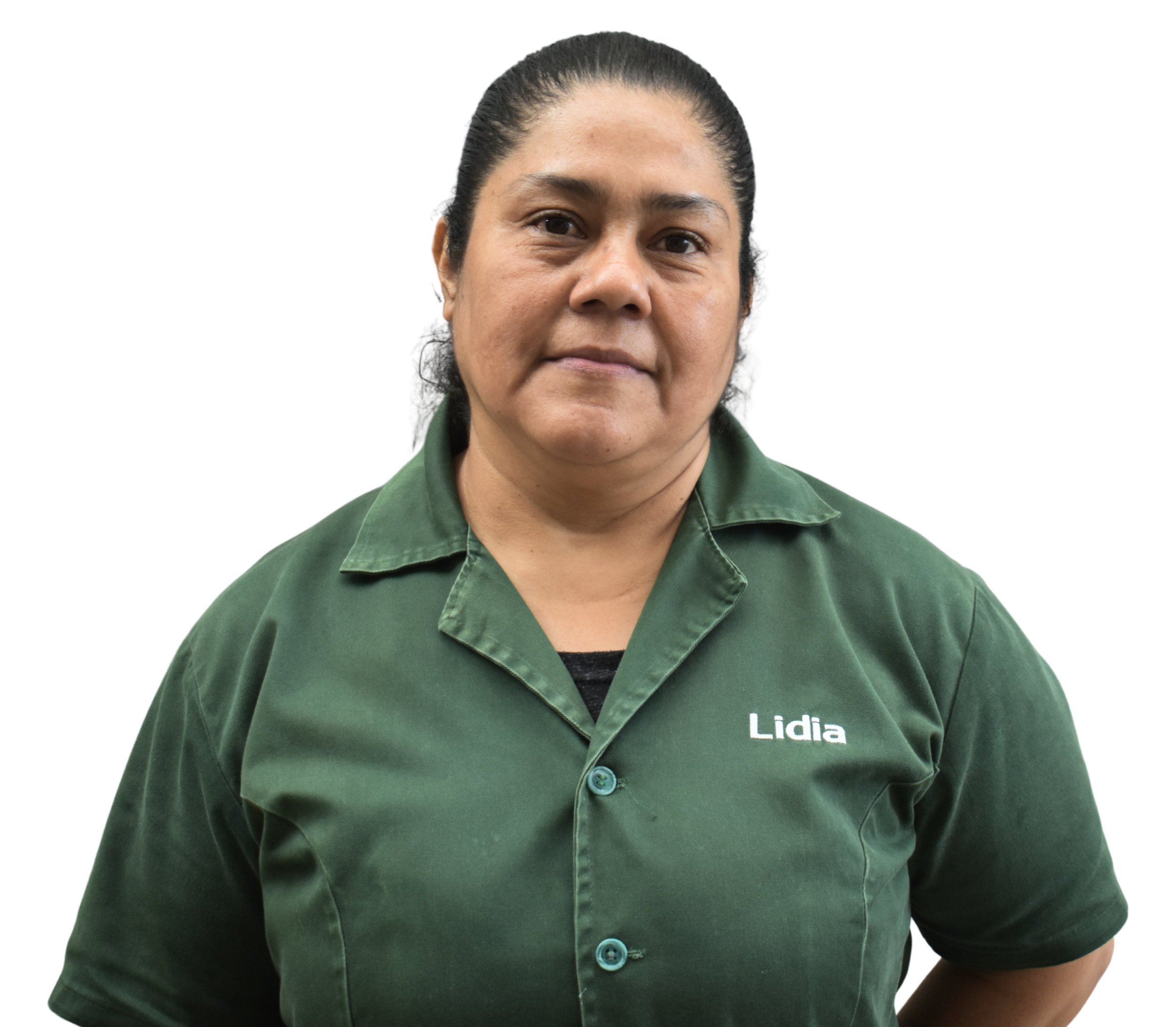 A woman with dark hair pulled back, wearing a green collared shirt with her name, 'Lidia,' embroidered on it, standing against a black background.