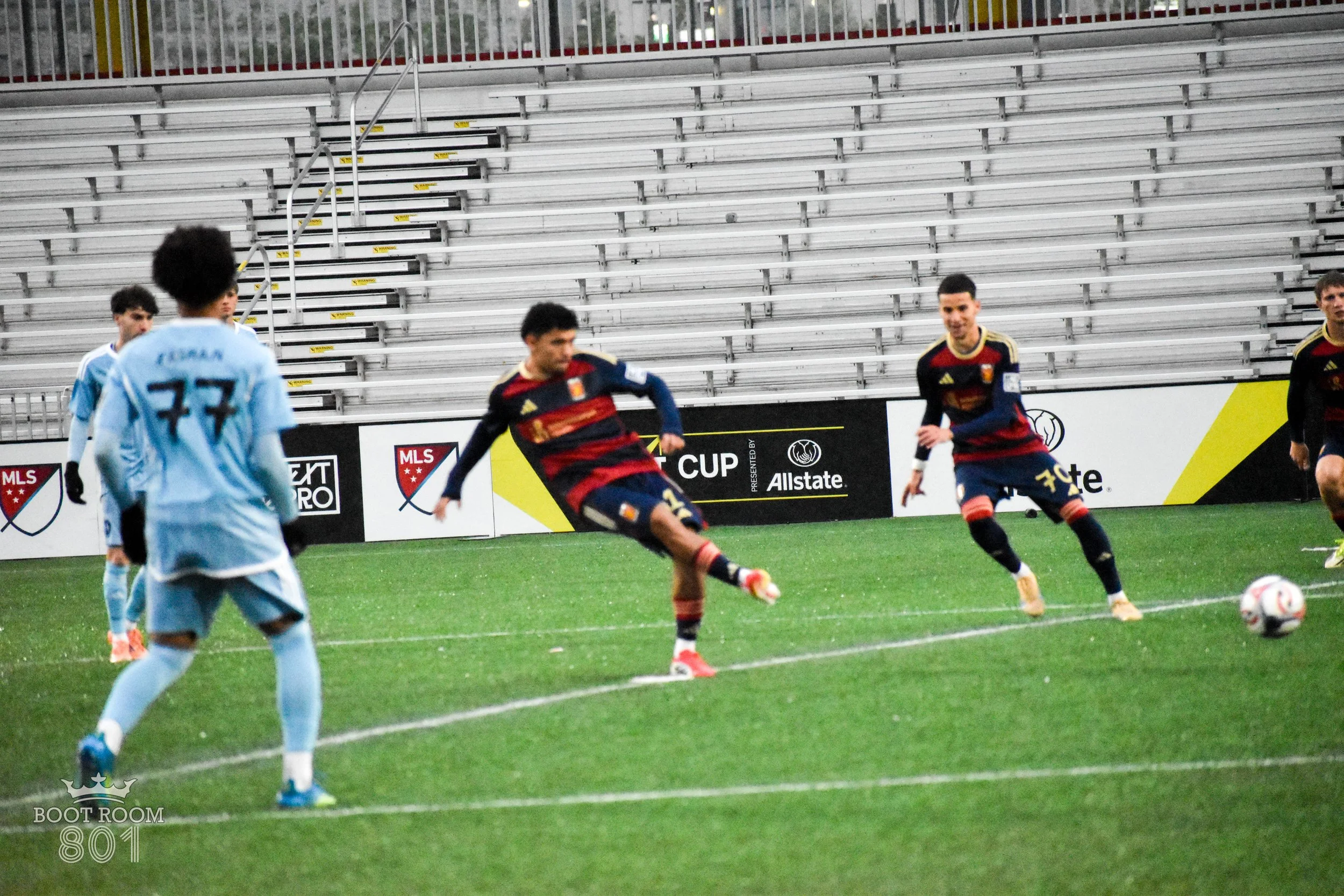 Izzy Amparo kicking off the match between Real Monarchs and Sporting Kansas City 2. Balanced with players on either side of him along the same planar line.