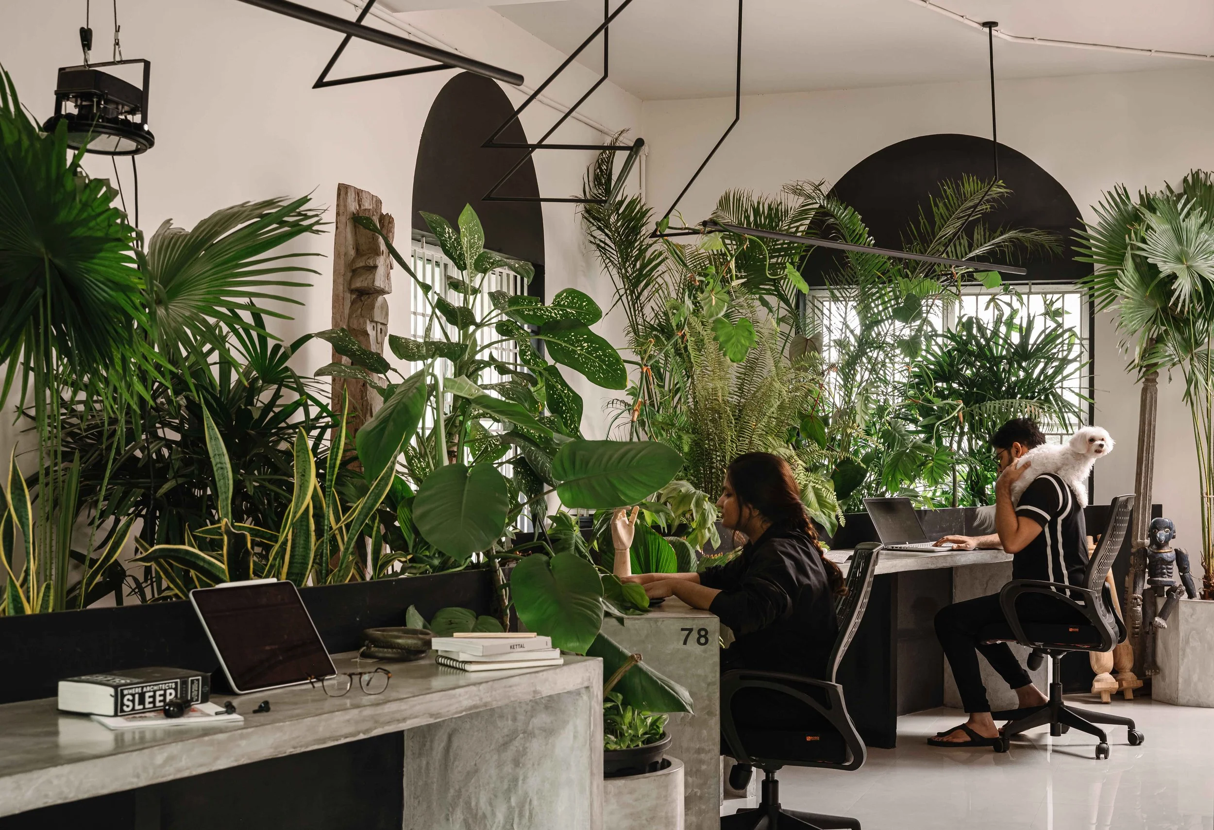Open office at Second Home by Workers of Art featuring custom workstations, indoor planting, and nature-inspired contemporary office design in Kochi, India.