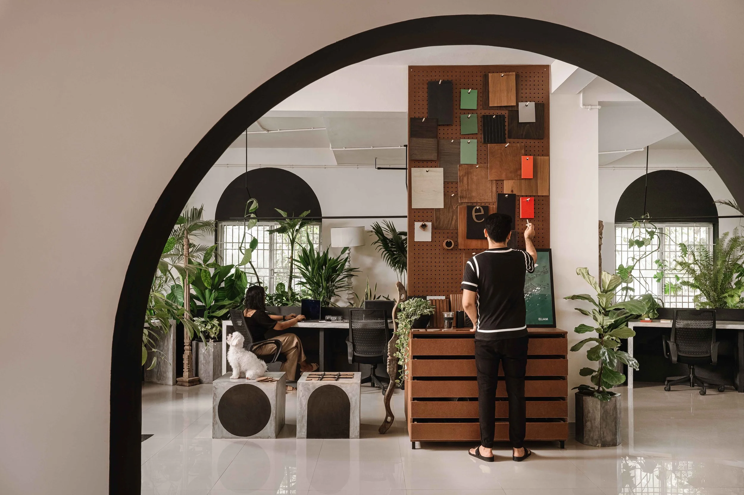 Studio interior at Second Home by Workers of Art featuring a curated material display wall, biophilic workspaces, and contemporary office design in Kochi, India.