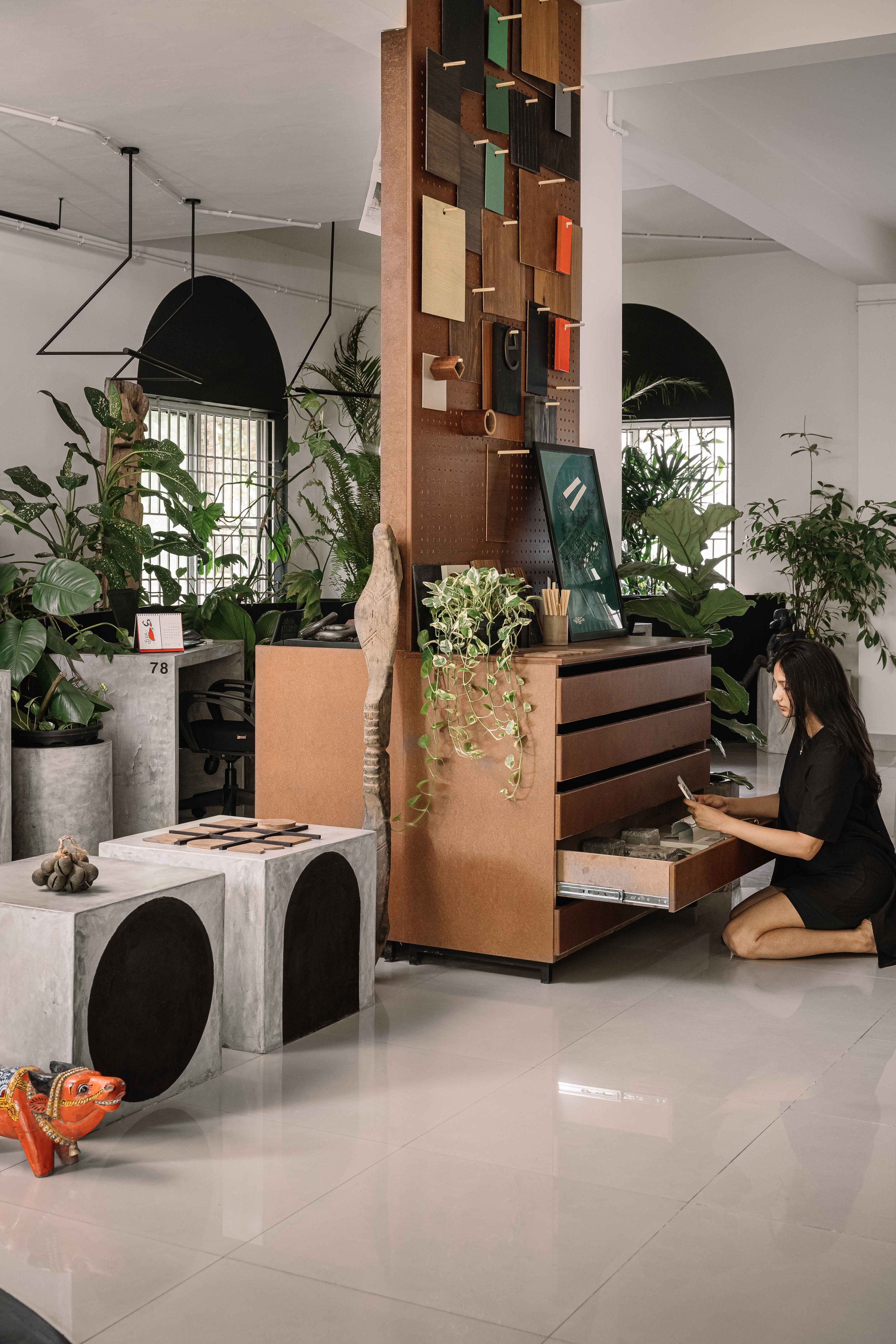Design library at Second Home by Workers of Art featuring a bespoke material display, custom storage, and contemporary workspace design in Kochi, India.