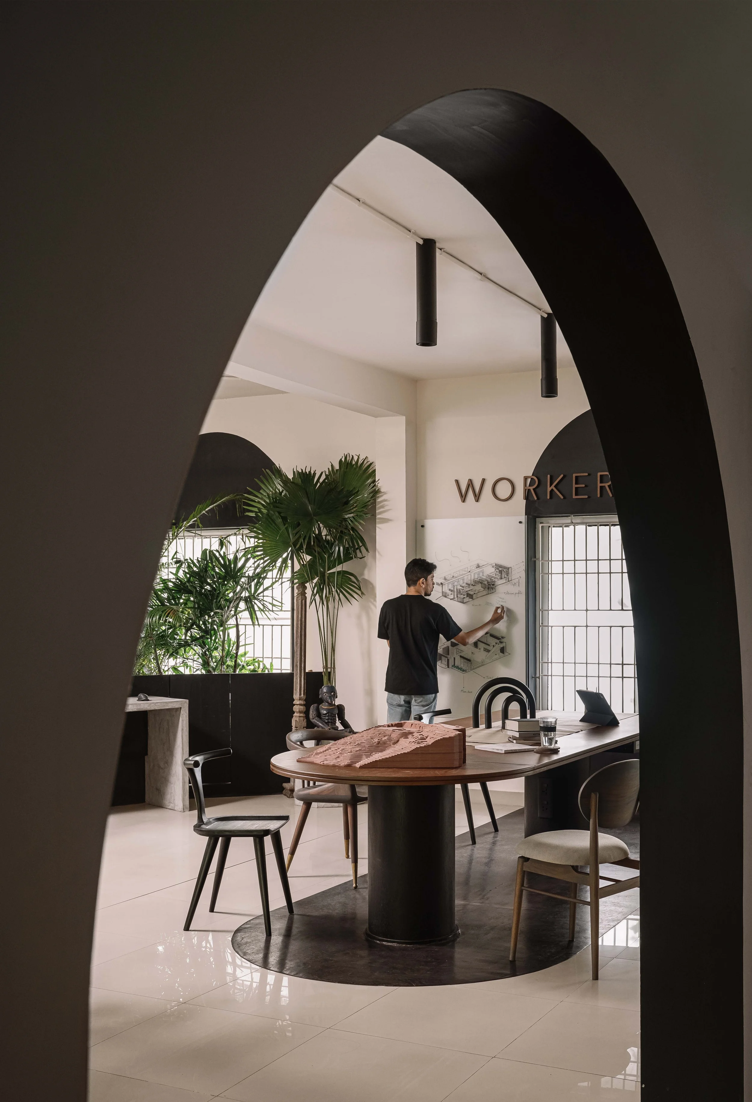 Collaborative workspace at Second Home by Workers of Art featuring custom furnishings, architectural models, and contemporary office design in Kochi, India.