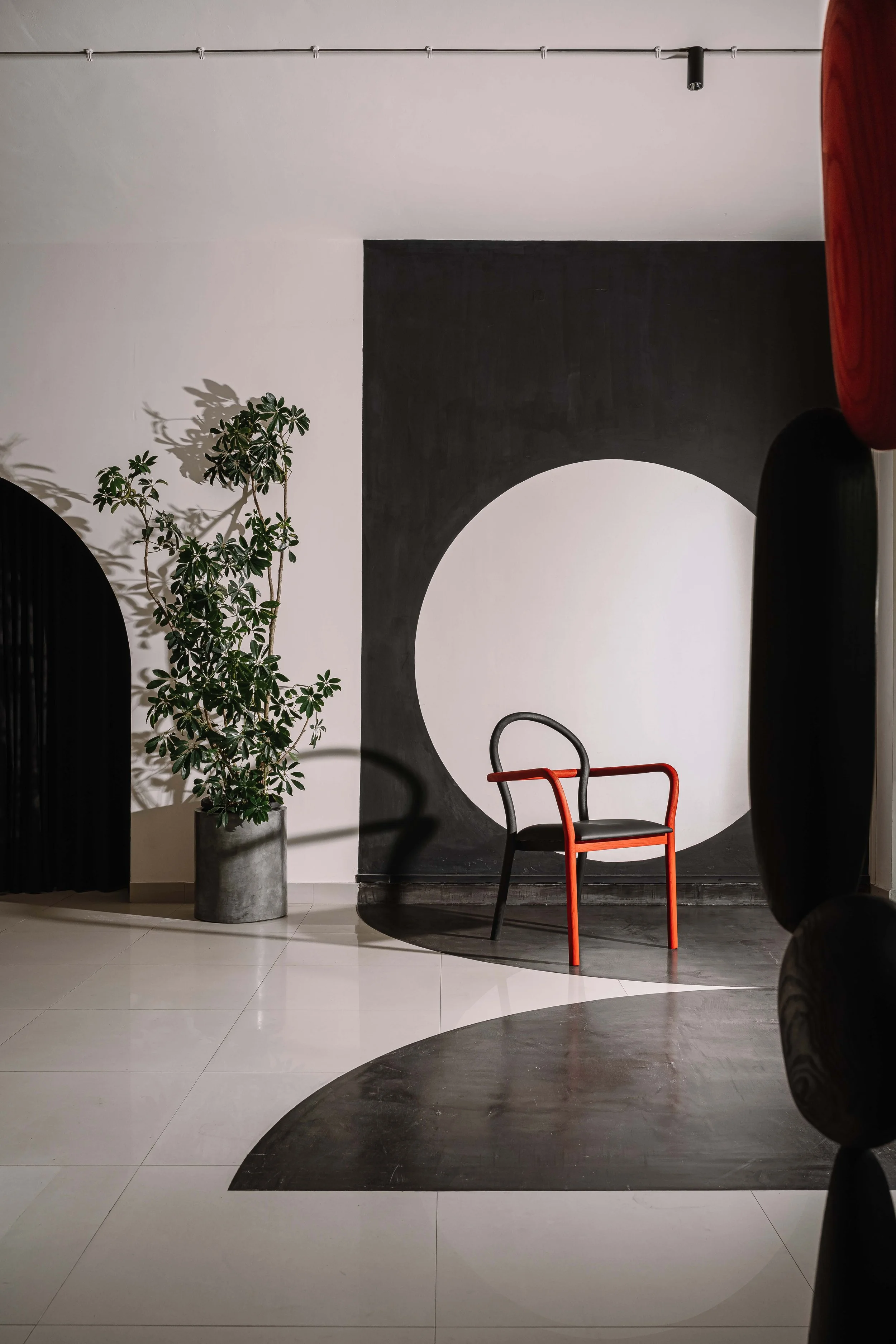 Office interior at Second Home by Workers of Art featuring a bespoke statement chair, geometric wall art, and minimalist workspace design in Kochi, India.