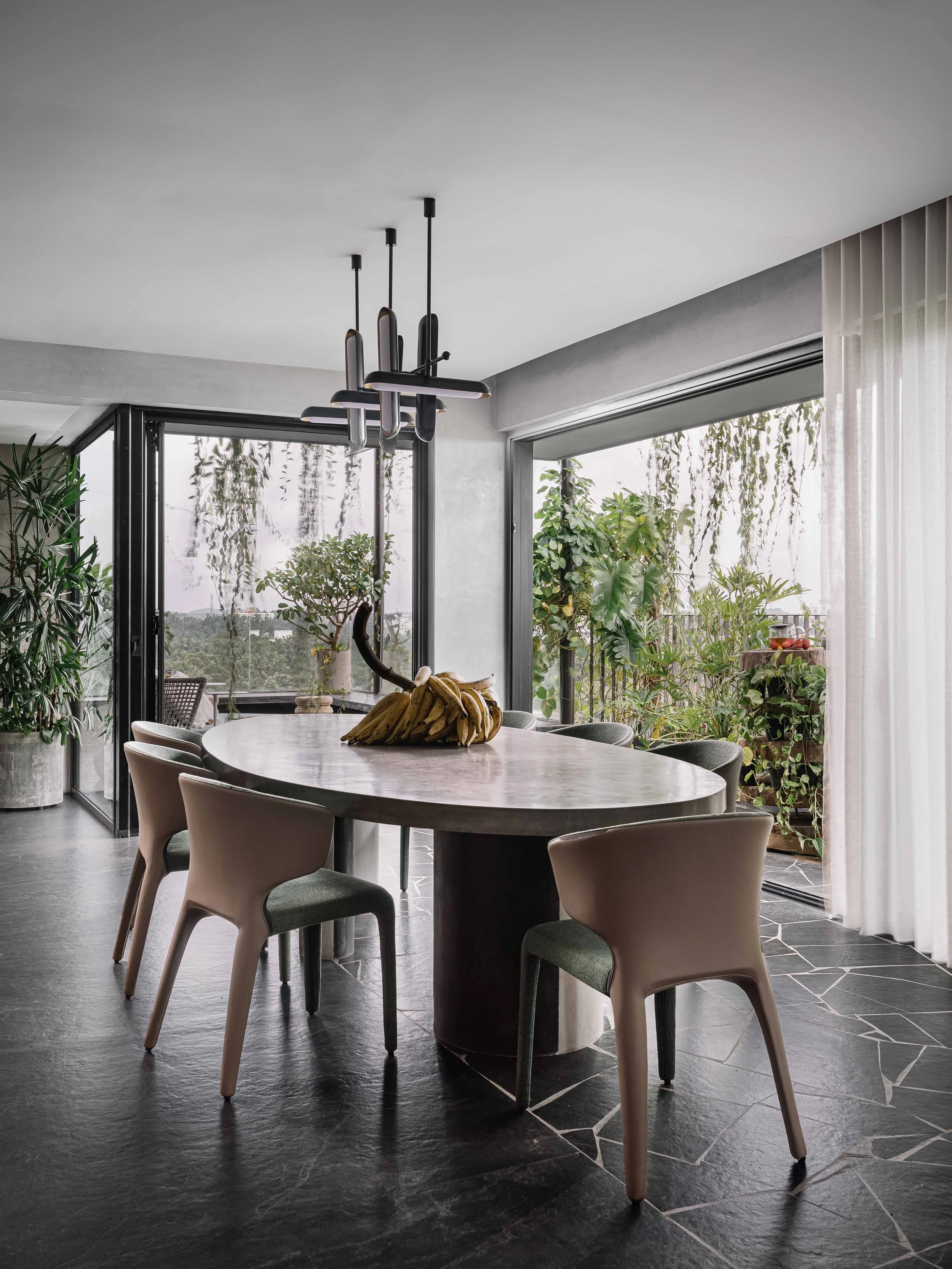 Dining space surrounded by balcony garden views with broken tile mosaic flooring