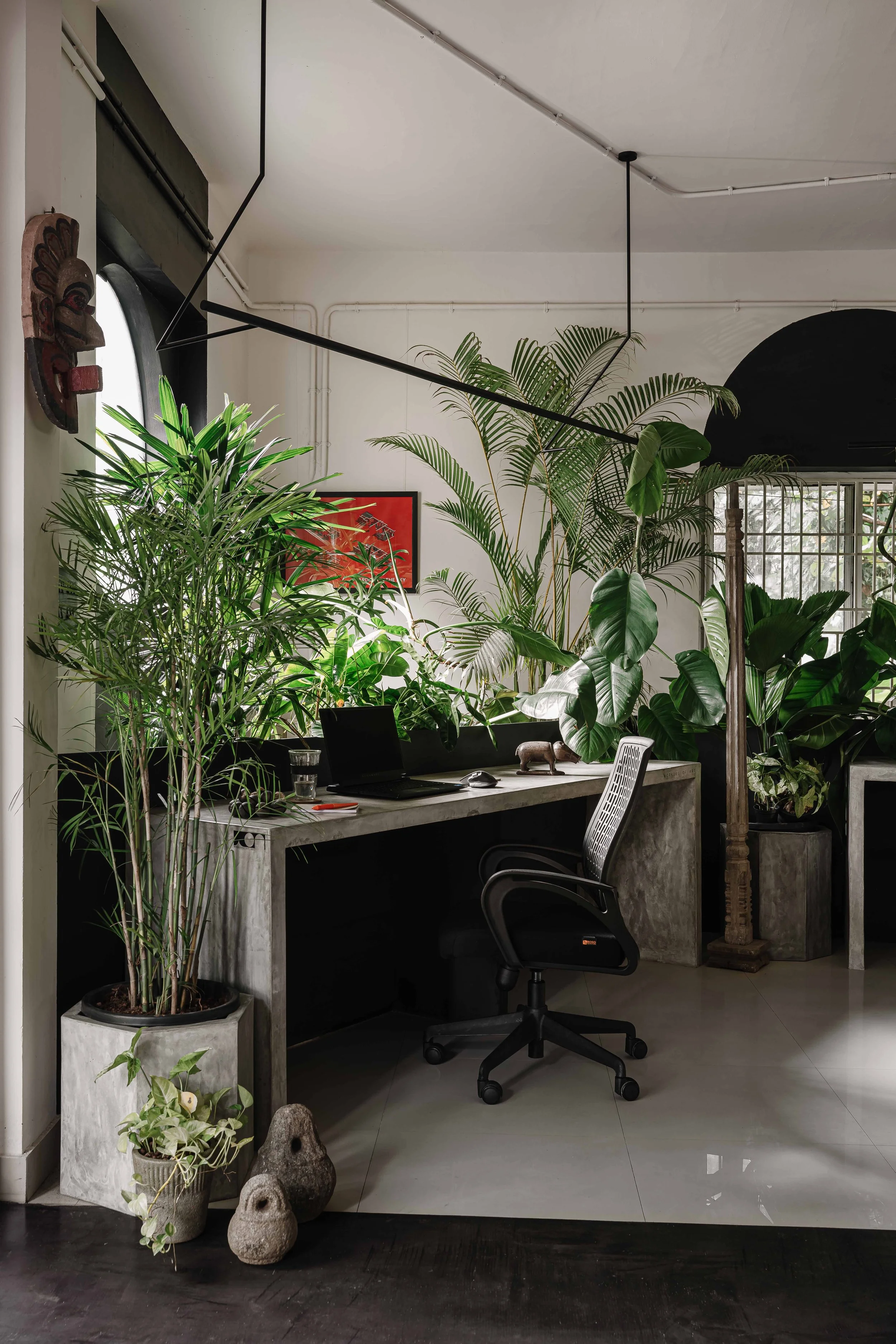 Office workspace at Second Home by Workers of Art featuring tropical indoor plants, minimalist interiors, and biophilic design in Kochi, India.