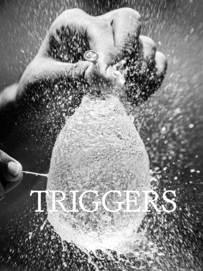 A close-up of a hand gripping a grenade, with water splashing around it and the word 'TRIGGERS' written across the bottom.