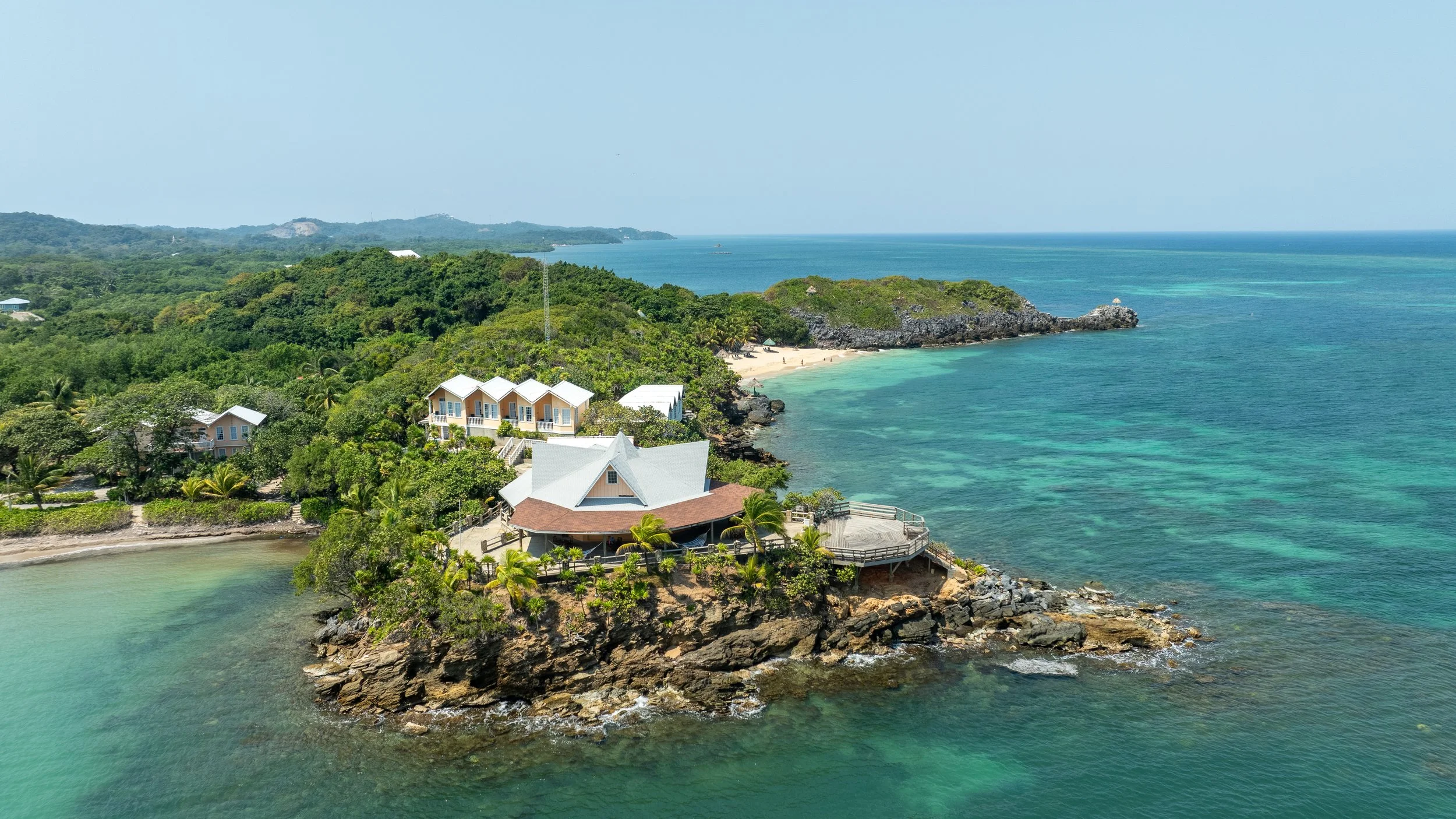 Drone shot of Solstice Rising Co retreat location at Paya Bay, with jungle coastline and crystal-clear sea