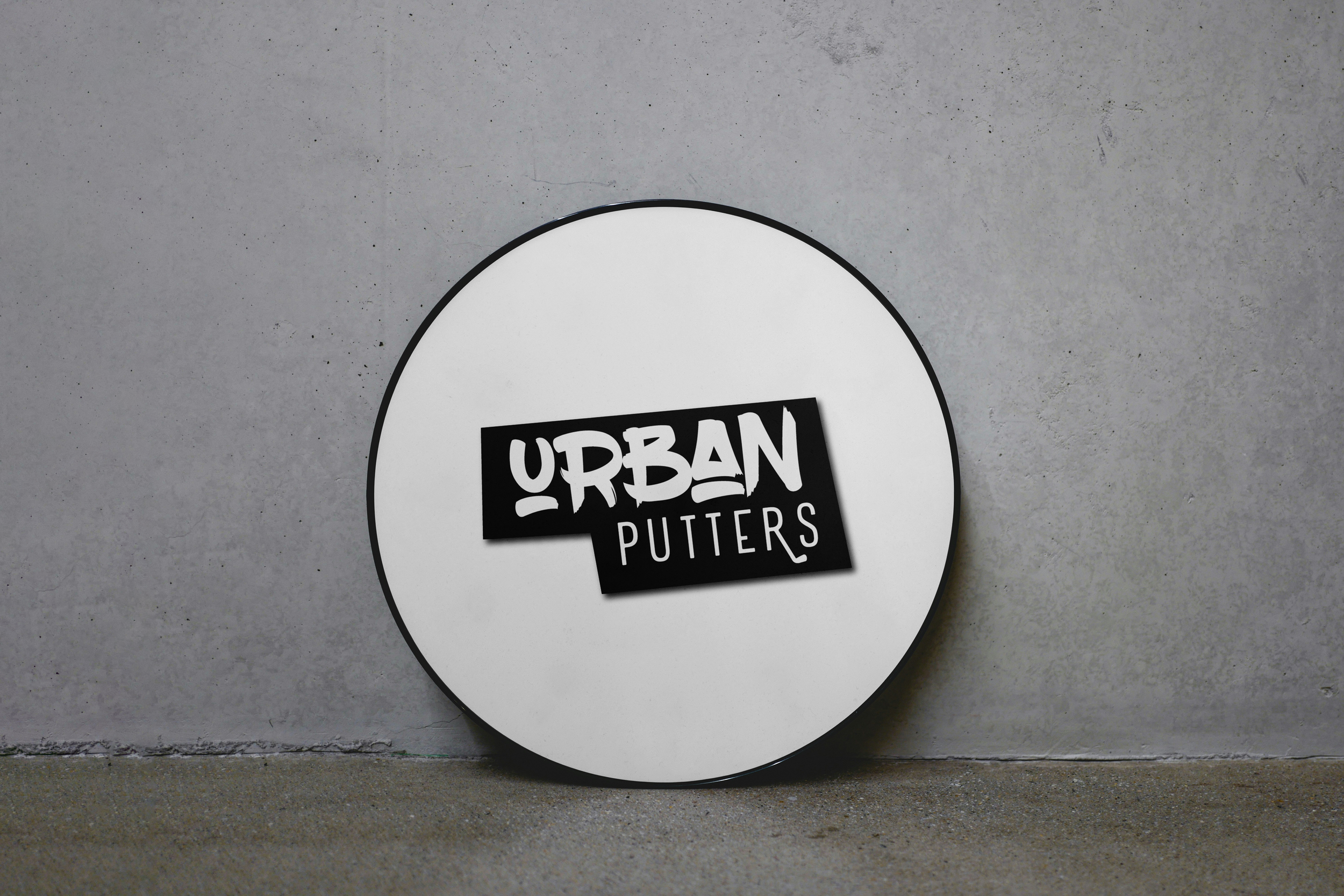 A mockup of the Urban Putters primary logo as a boxlight sign