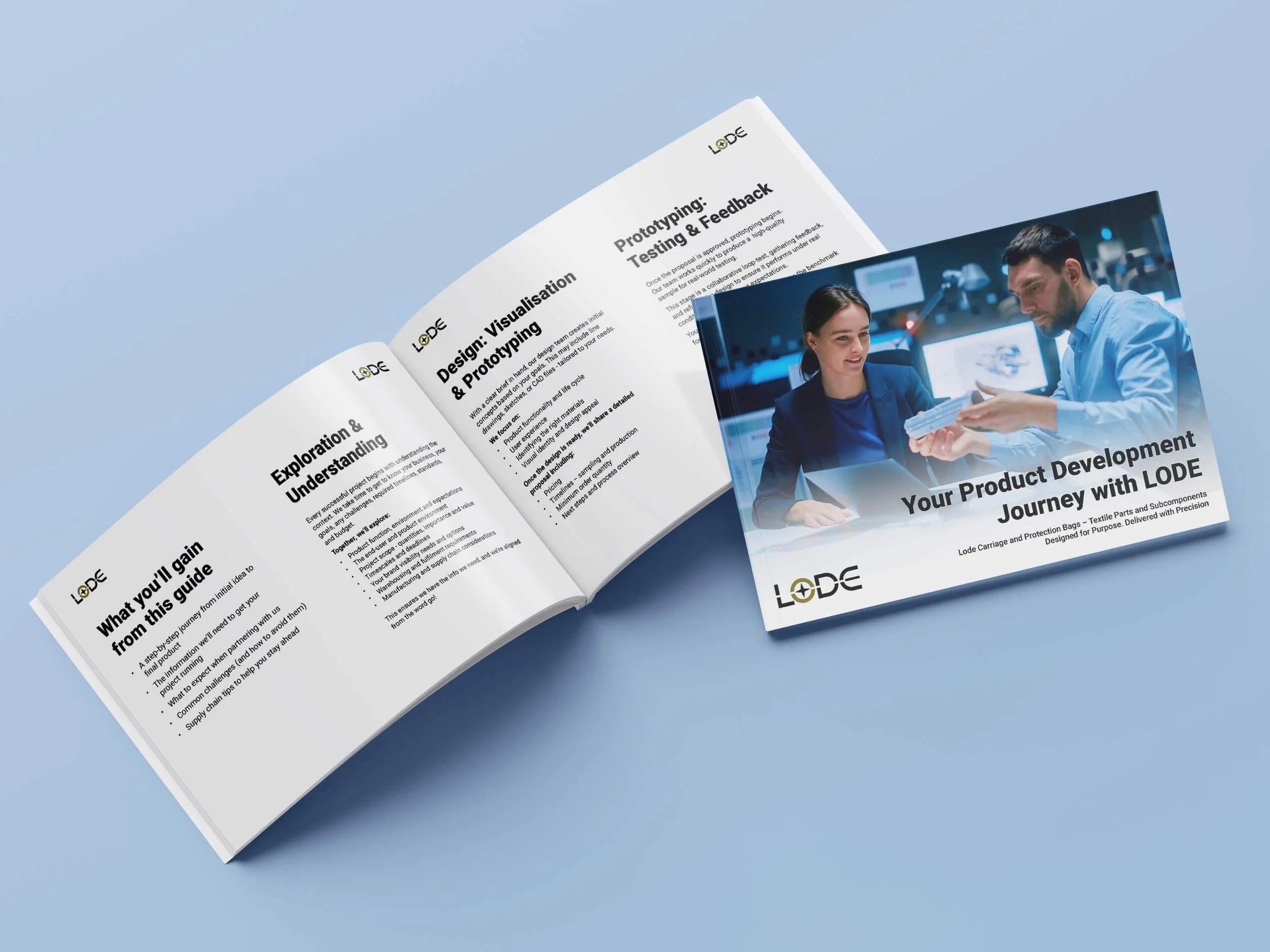 LODE Product Development Journey booklet with black text laying open on a blue surface, next to a black and blue brochure featuring a man and woman discussing a product in a high-tech environment.