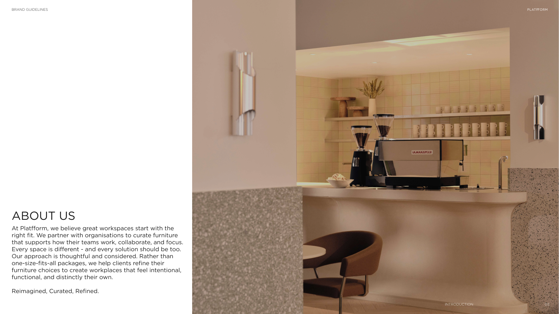 Interior of a modern coffee shop with a La Marzocco espresso machine, two coffee grinders, shelves with mugs, and minimal decor including a vase with dried plants.