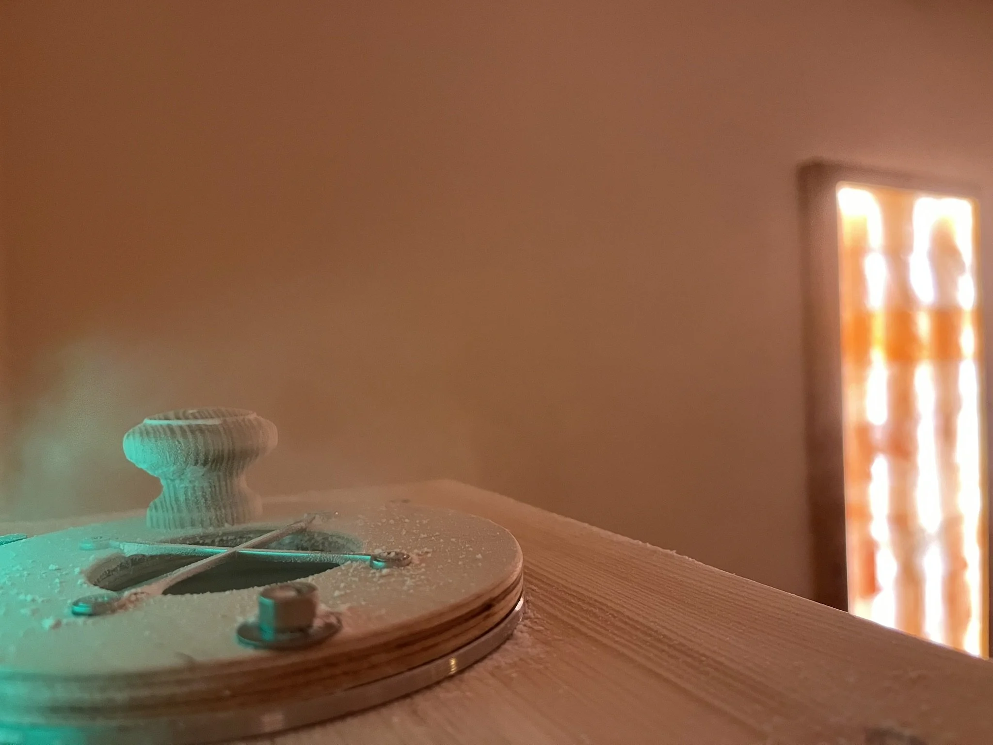 Close-up of a halogenerator, in the background there is a Himalayan salt tile frame.