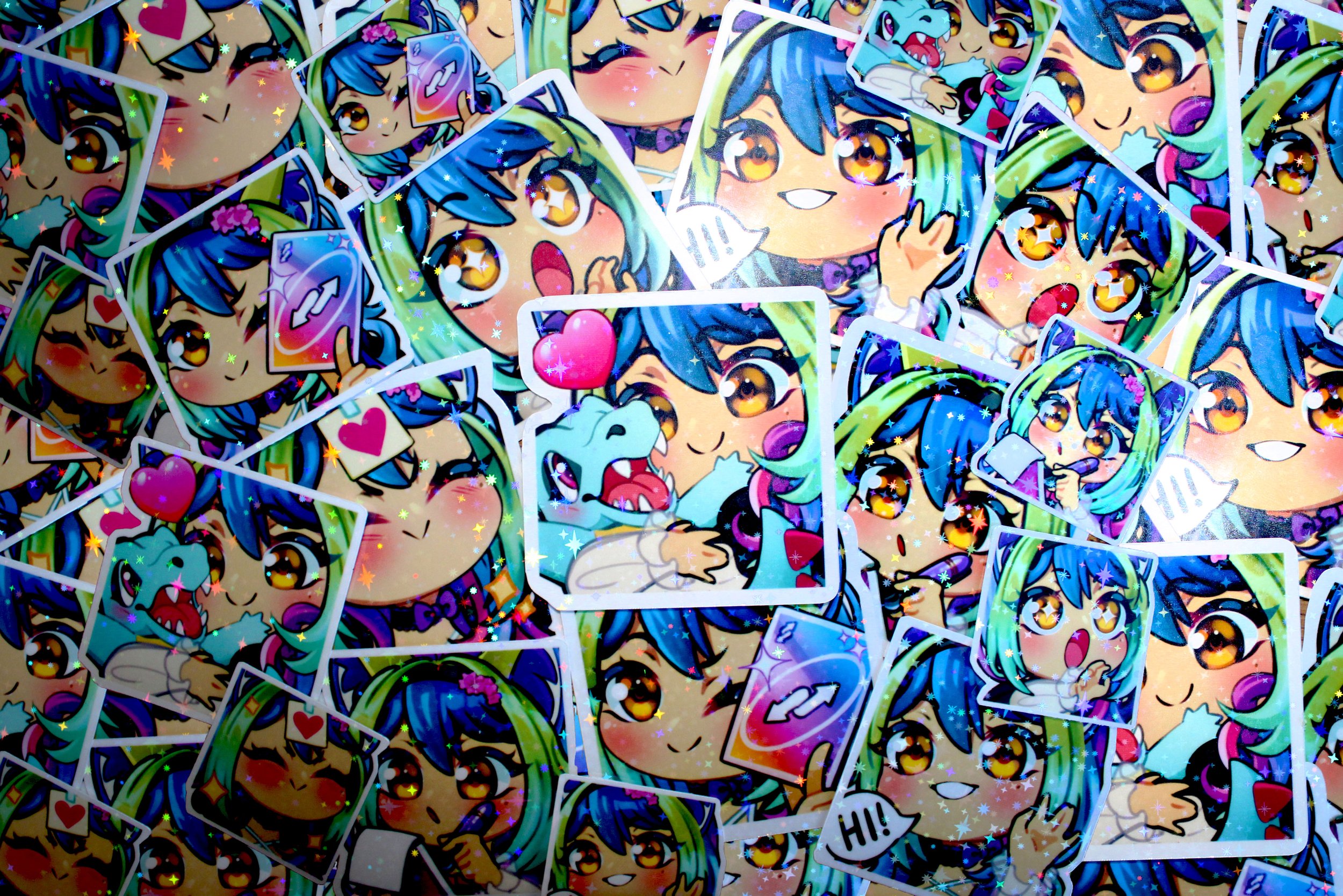 A pile of colorful anime-style stickers featuring a girl with blue and green hair, big expressive eyes, and various facial expressions, some with speech bubbles.