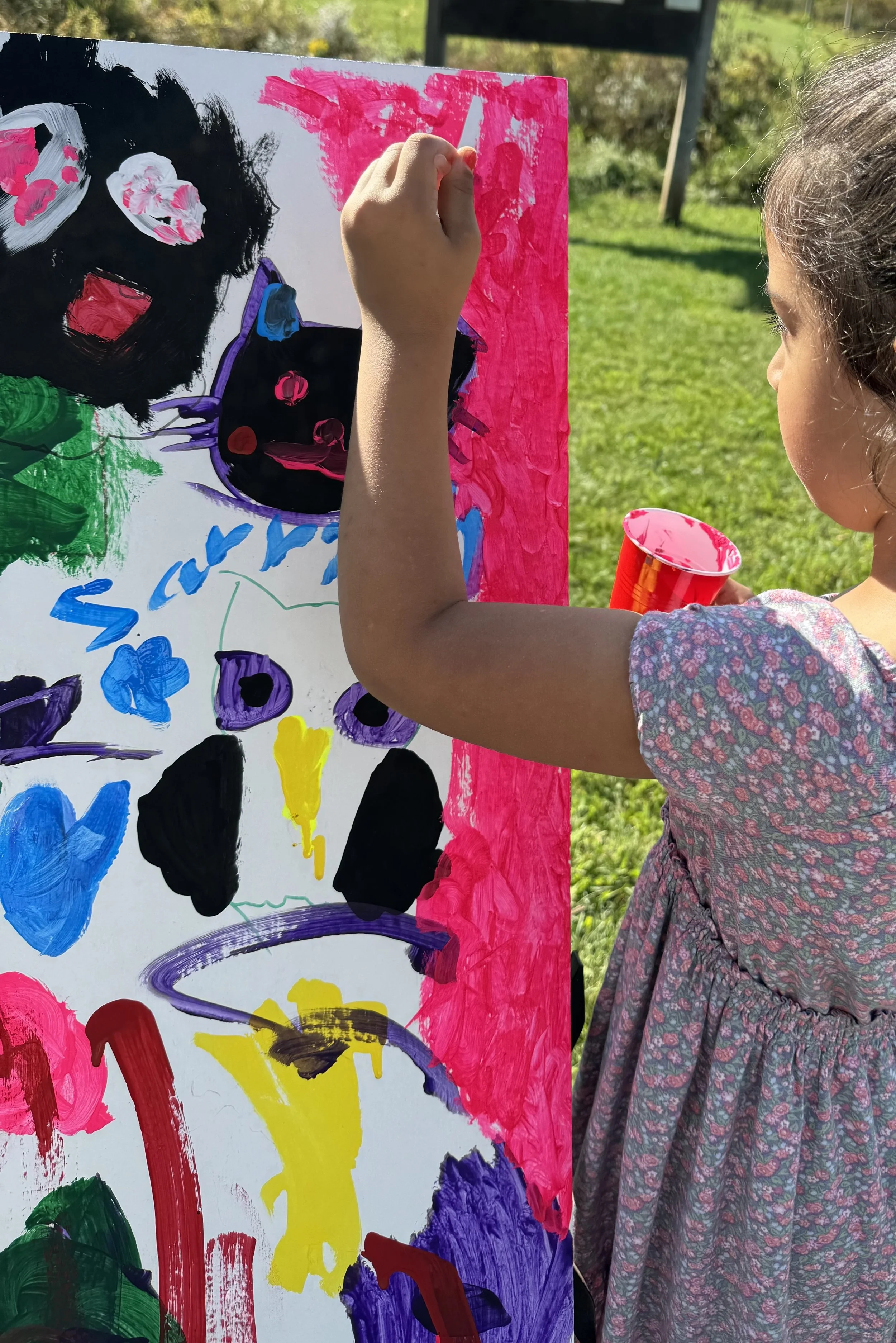 Child painting mural outdoors.jpg