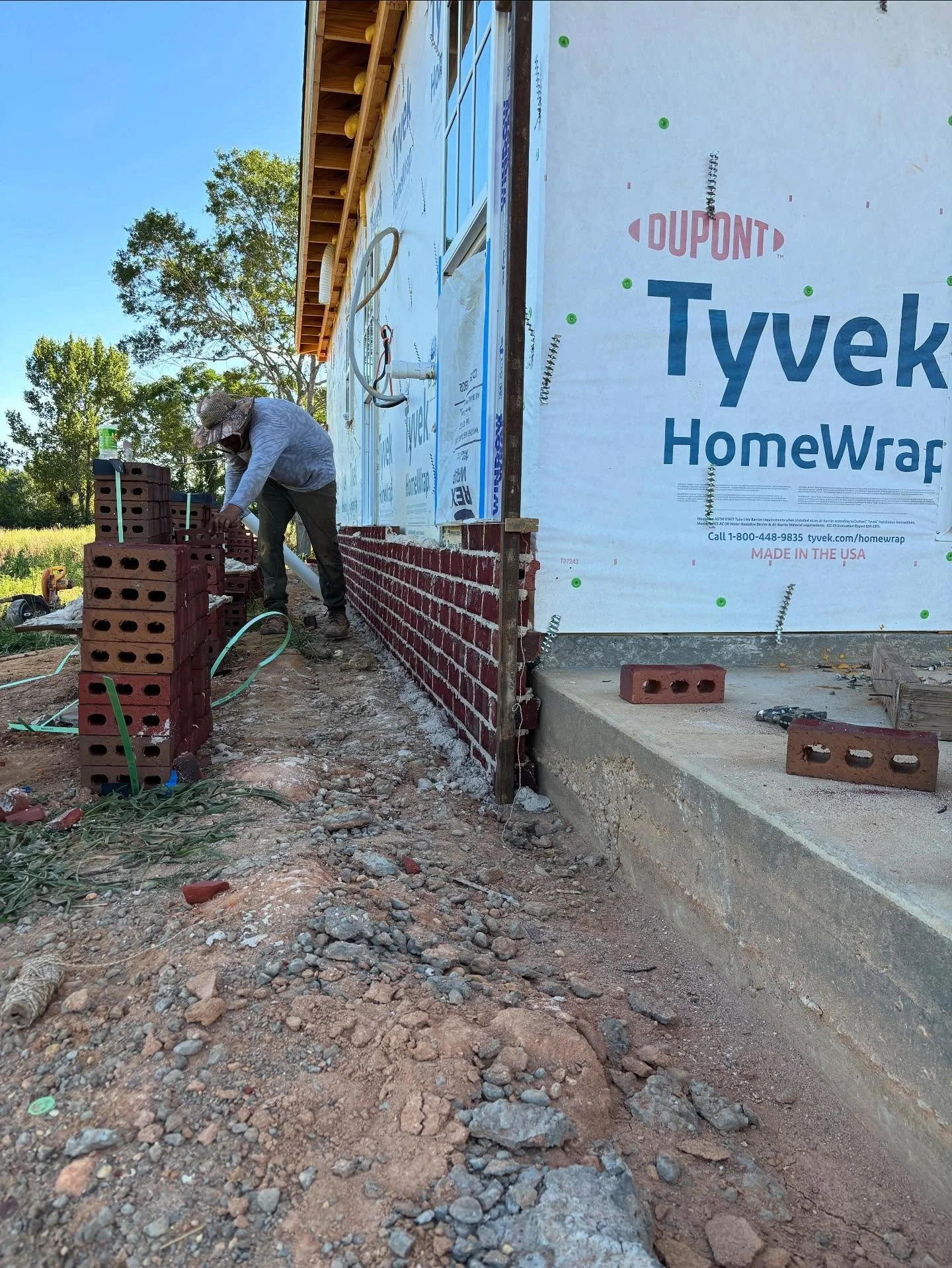 Classic dark red brick with white mortar going up at the first Harper Joy Rd house